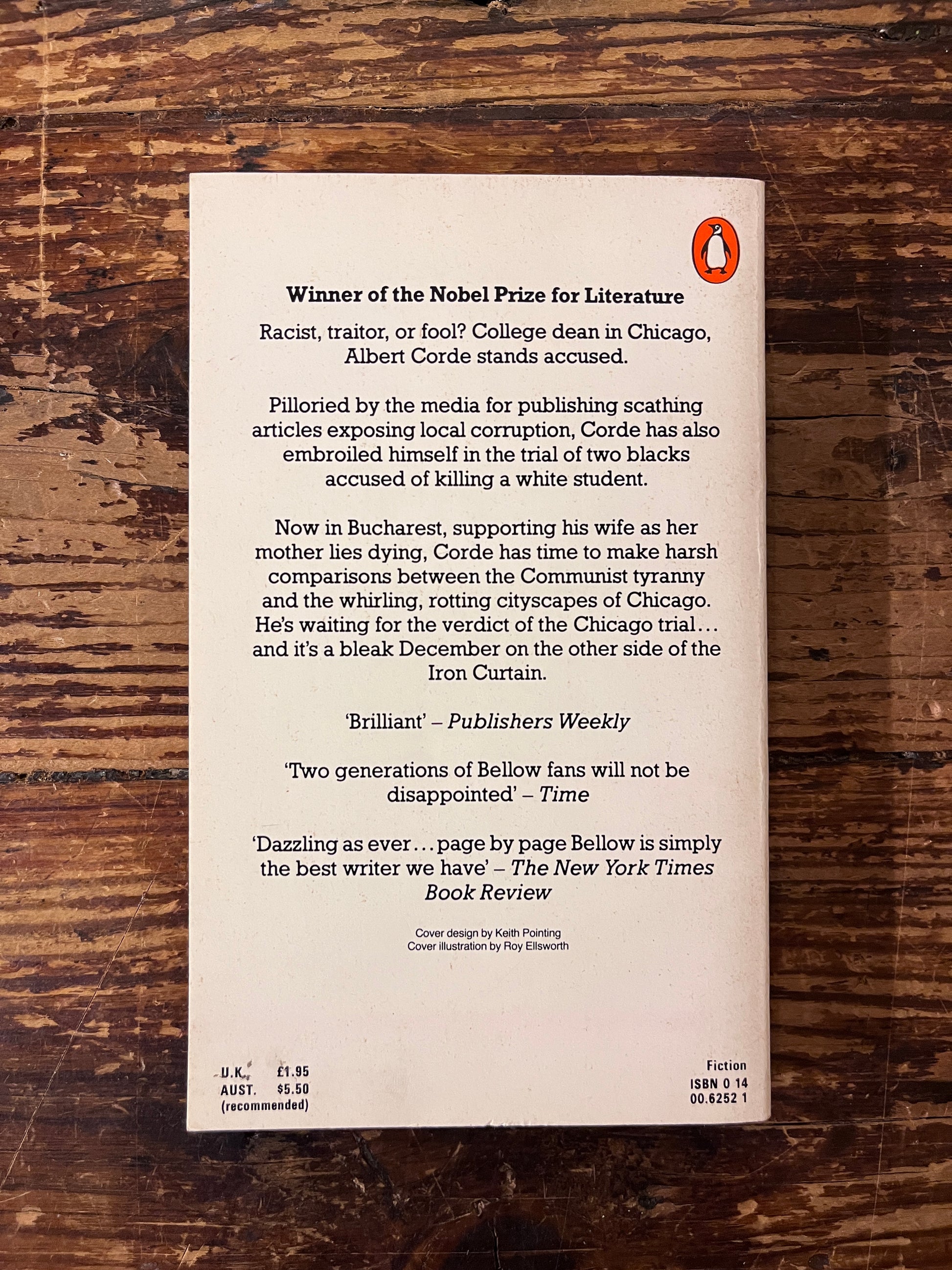 photo of the backcover of the book " the dean's december" on a wooden background