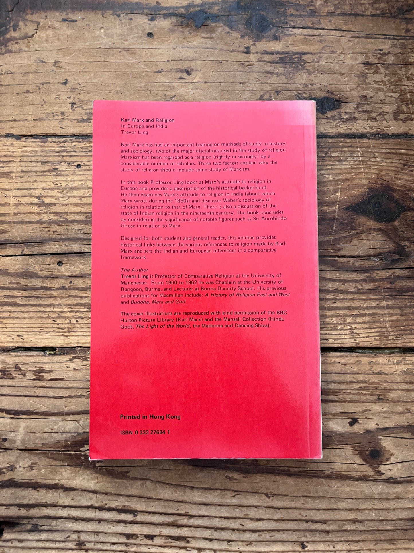 foto of the cover of the book "karl marx and religion in europe and india on a wooden background