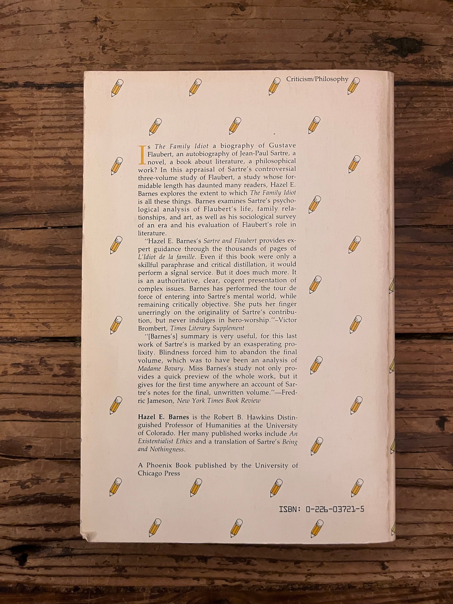 photo of the backcover of the book "Sartre & Flaubert"  on a wooden backround