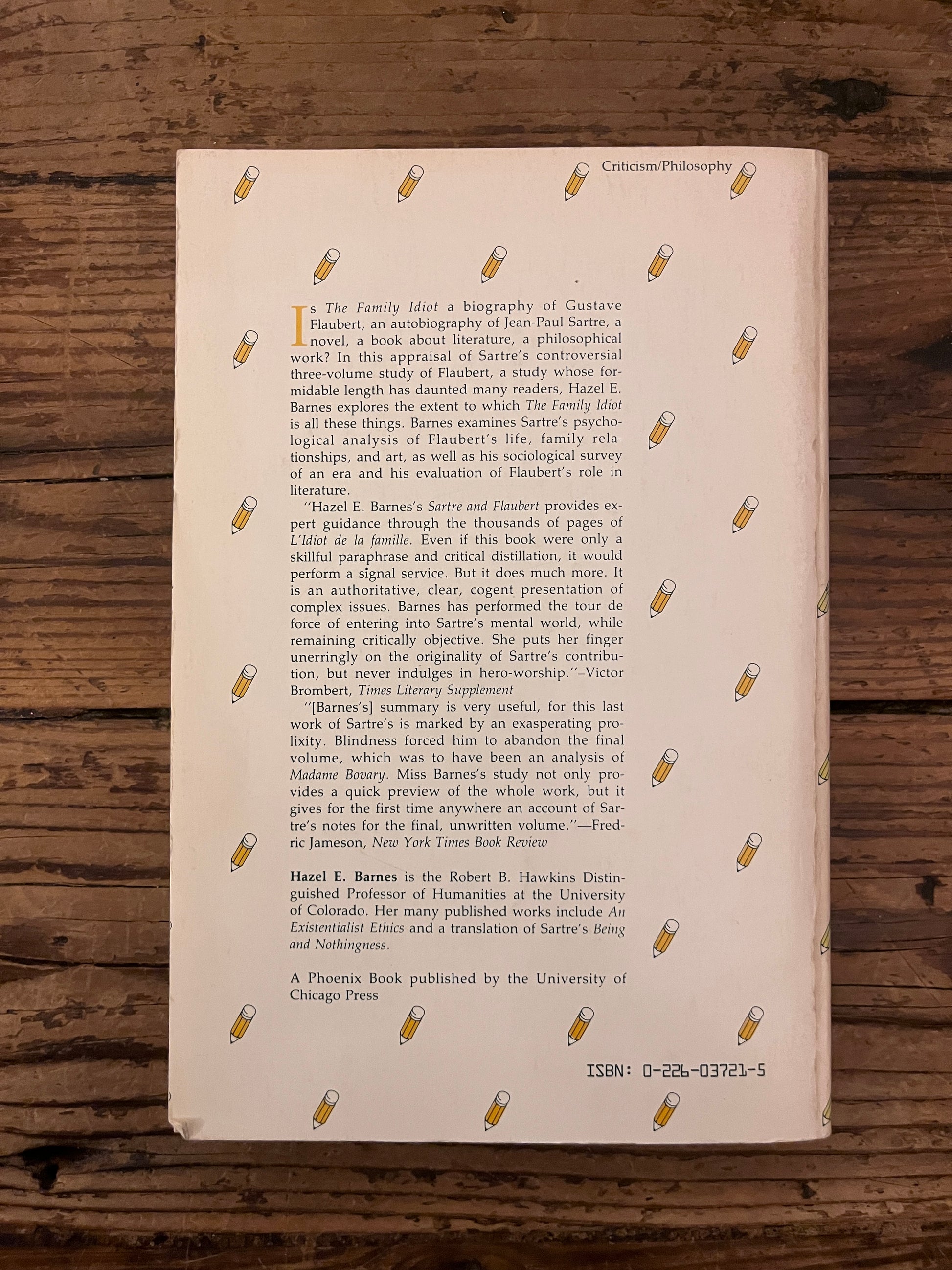 photo of the backcover of the book "Sartre & Flaubert"  on a wooden backround