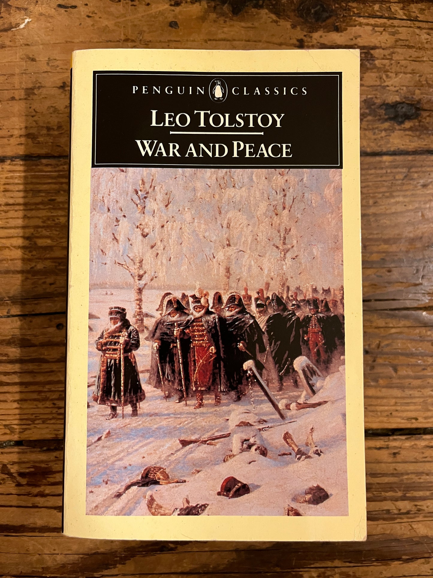 photo of the cover of the book " war and peace"on a wooden background