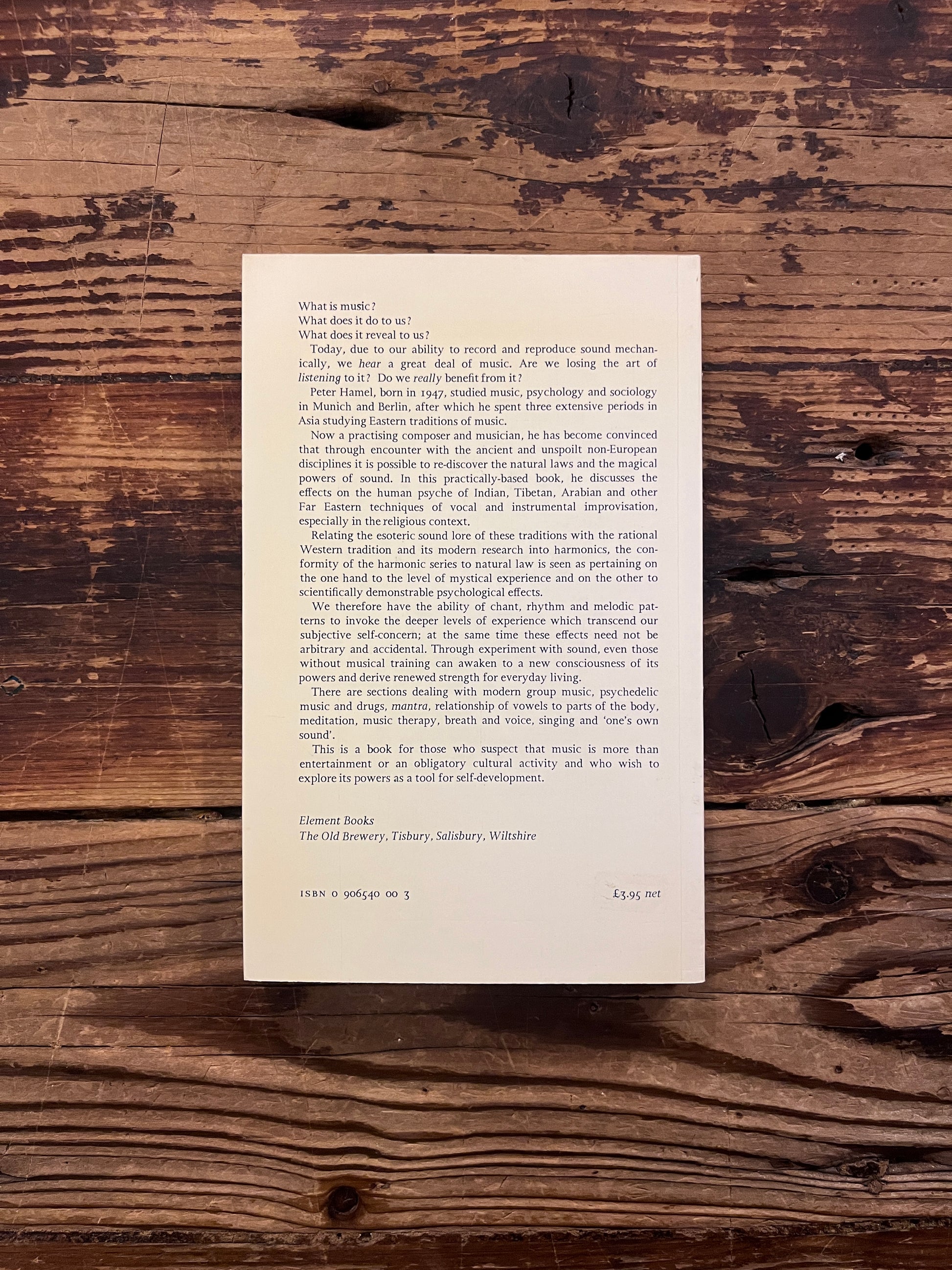 Book titled 'Through Music to the Self' by Peter Michael Hamel on a wooden surface