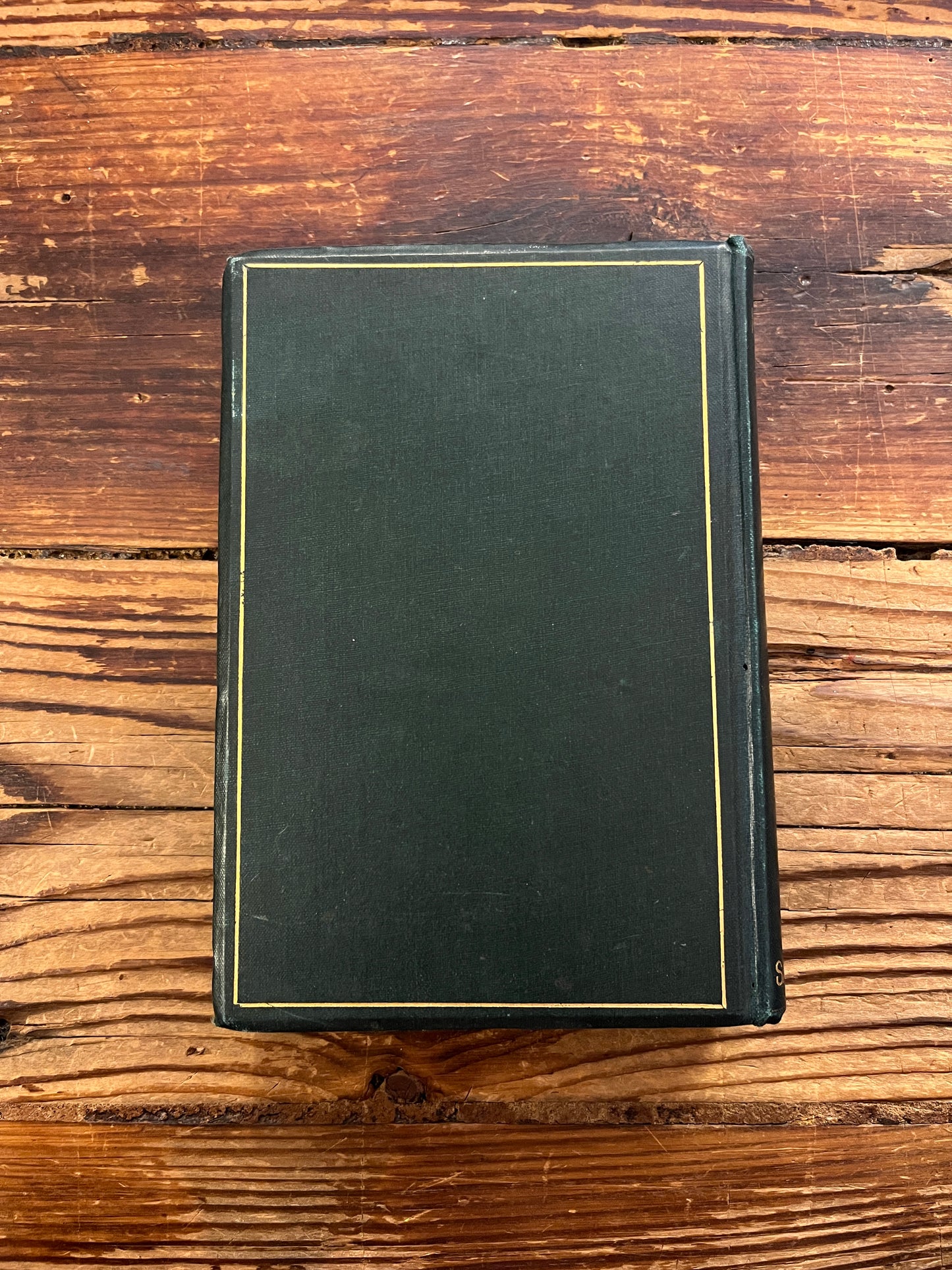 Back cover of book titled 'Poems of the Inner Life' on a wooden surface