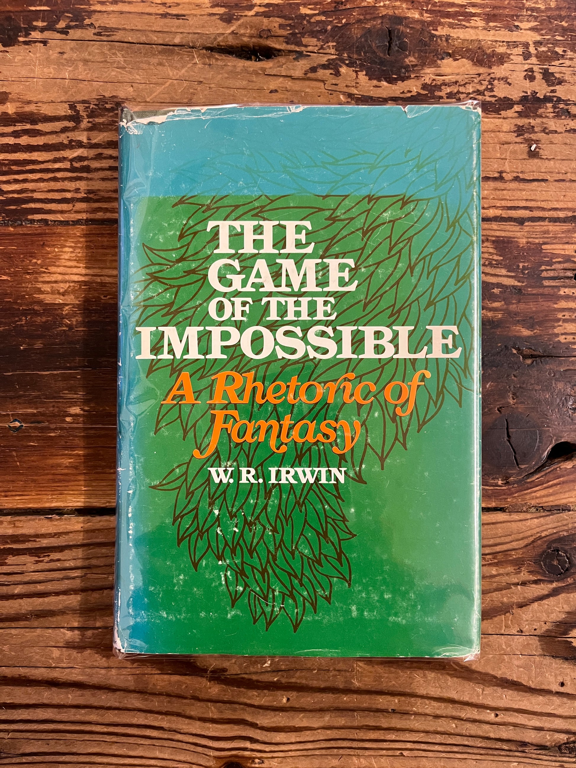 Front cover of book titled 'The Game of the Impossible: A Rhetoric of Fantasy' by W.R. Irwin on a wooden surface