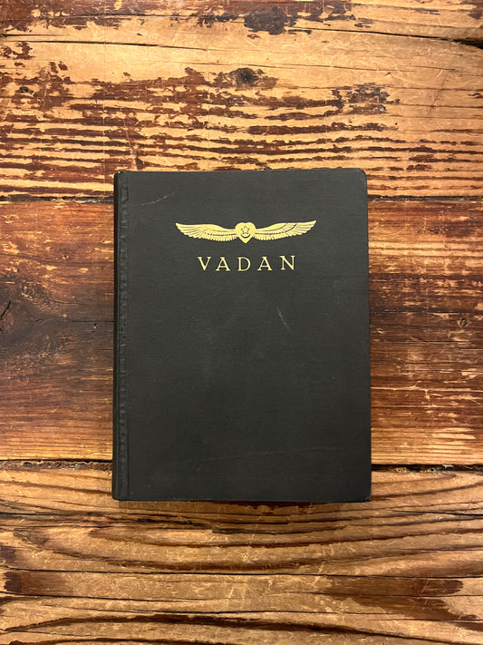 Front cover of book titled 'The divine symphony or Vadan'  by Hazrat Inayat Khan on a wooden surface 