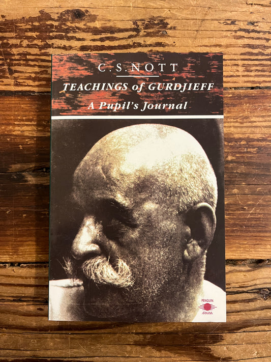 Book titled 'Teachings of Gurdjieff: A Pupil's Journal' by C.S. Nott on a wooden surface