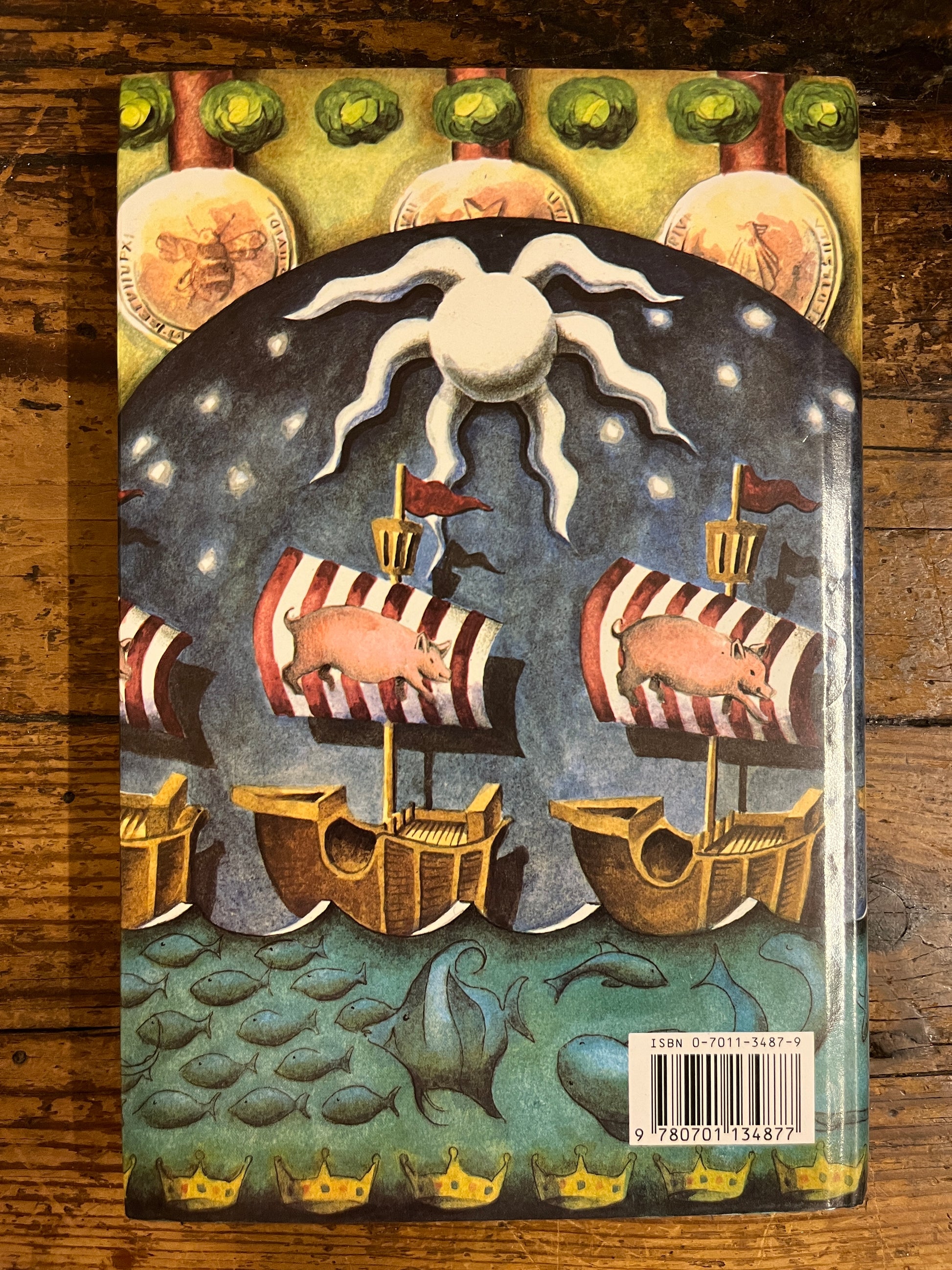 back cover of the book "The chatto book of cabbages and kings" on a wooden background 