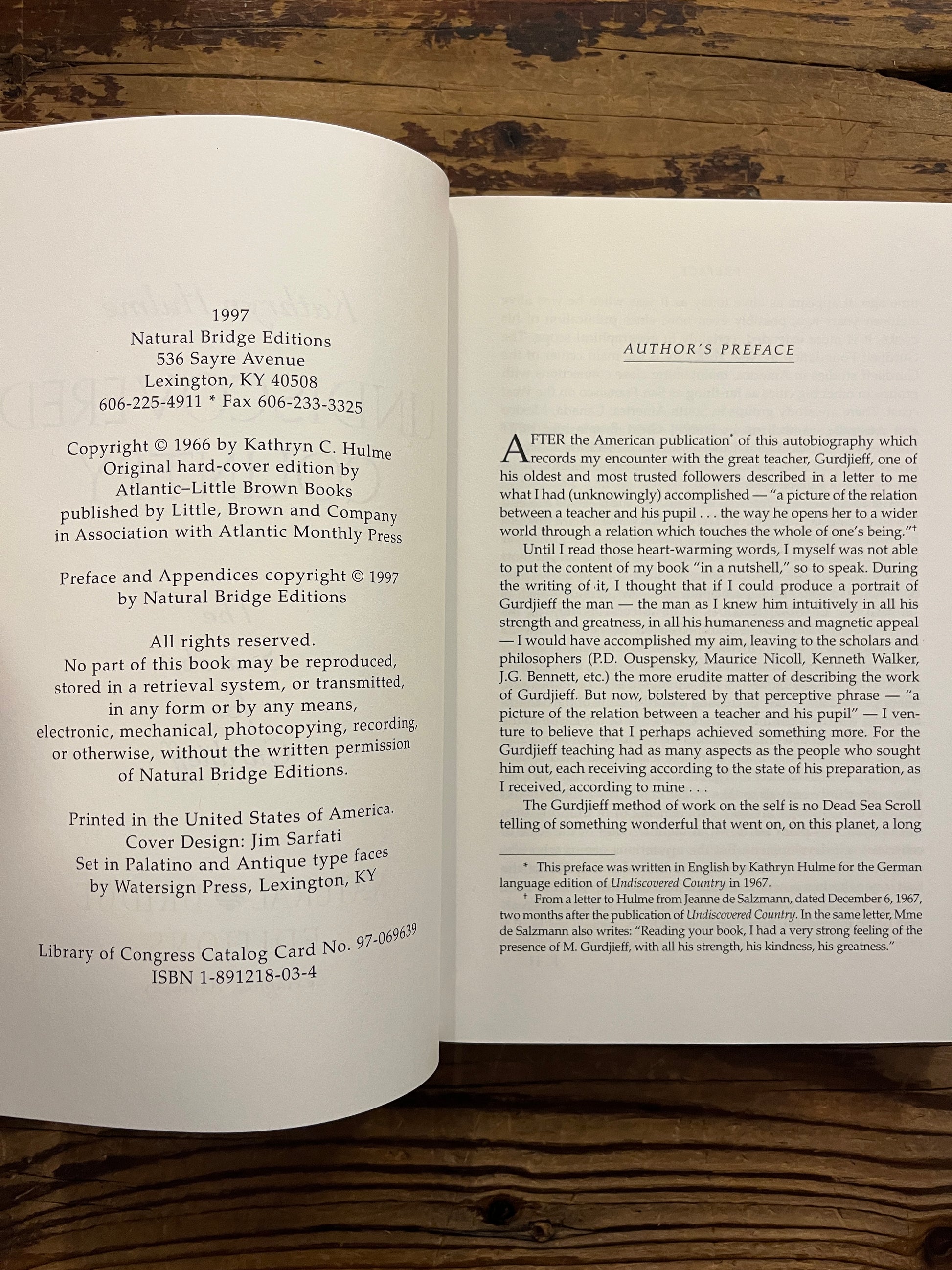 Open book titled 'Undiscovered Country: The Search for Gurdjieff' by Kathryn Hulme on a wooden surface