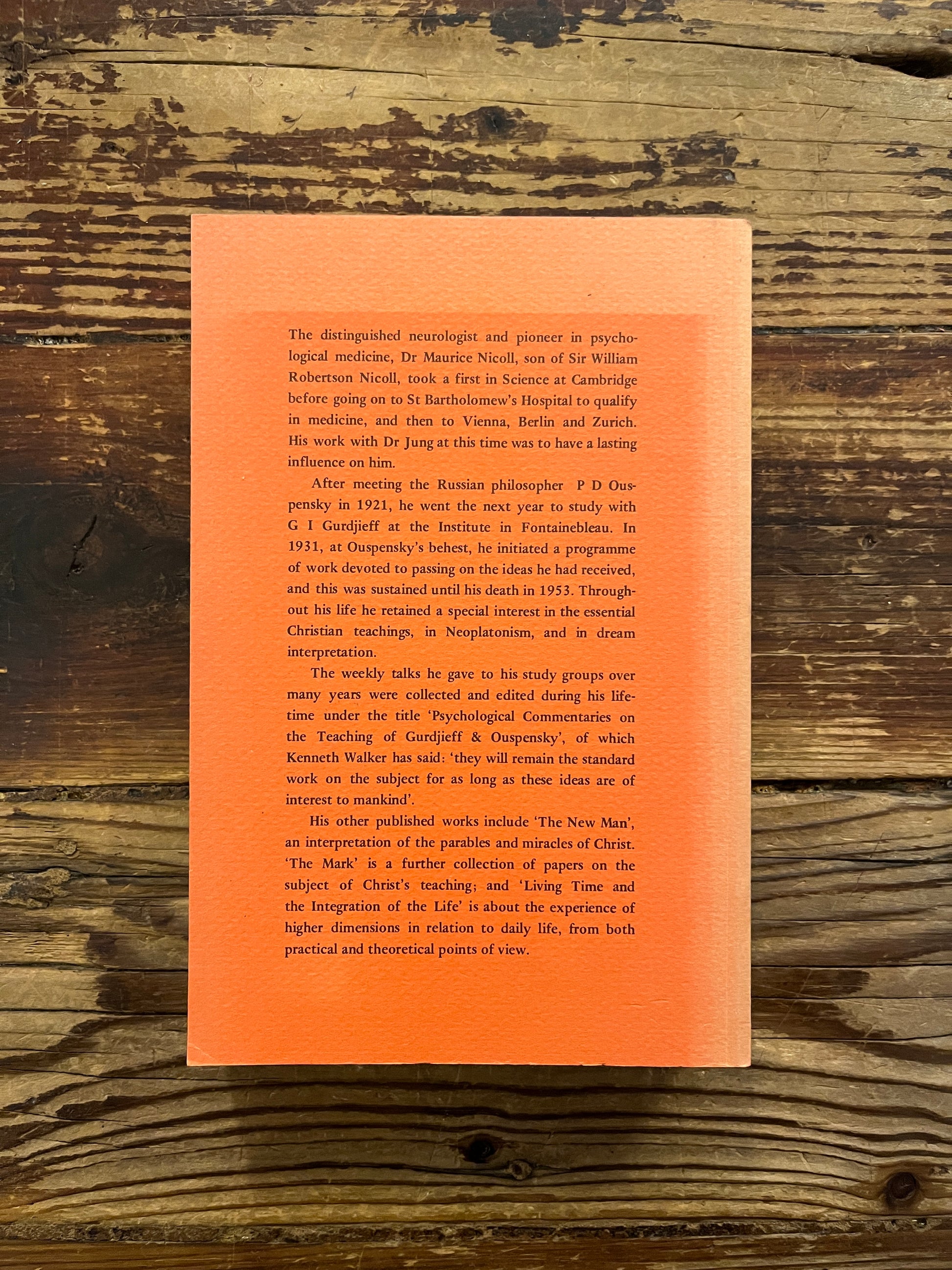 Book titled 'Psychological Commentaries on the Teaching of Gurdjieff & Ouspensky' by Maurice Nicoll on a wooden surface