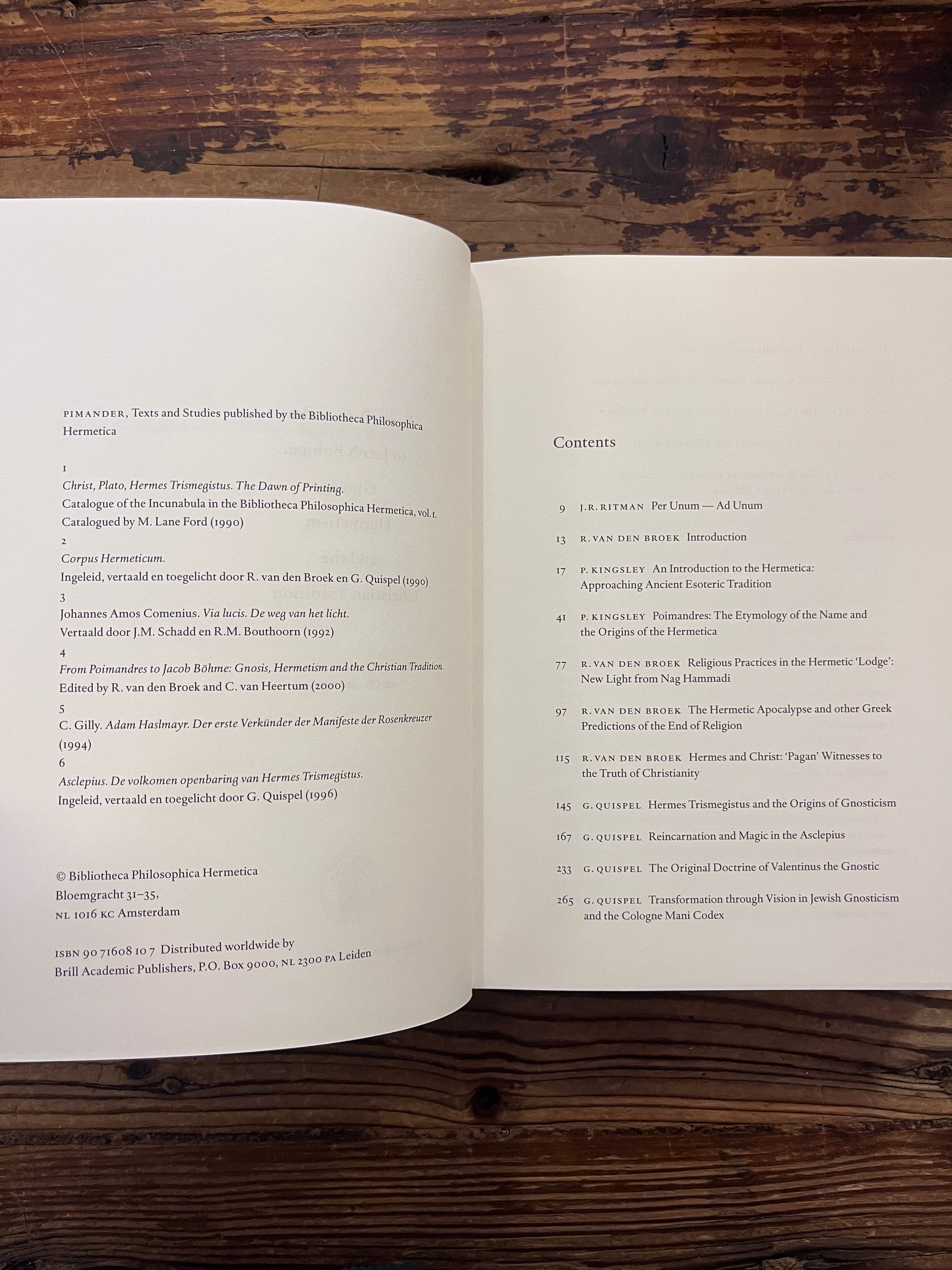 Open book titled 'From Poimandres to Jacob Böhme: Gnosis, Hermetism, and the Christian tradition Edited by Roelof van den Broek and Cis van Heertum' On a wooden surface