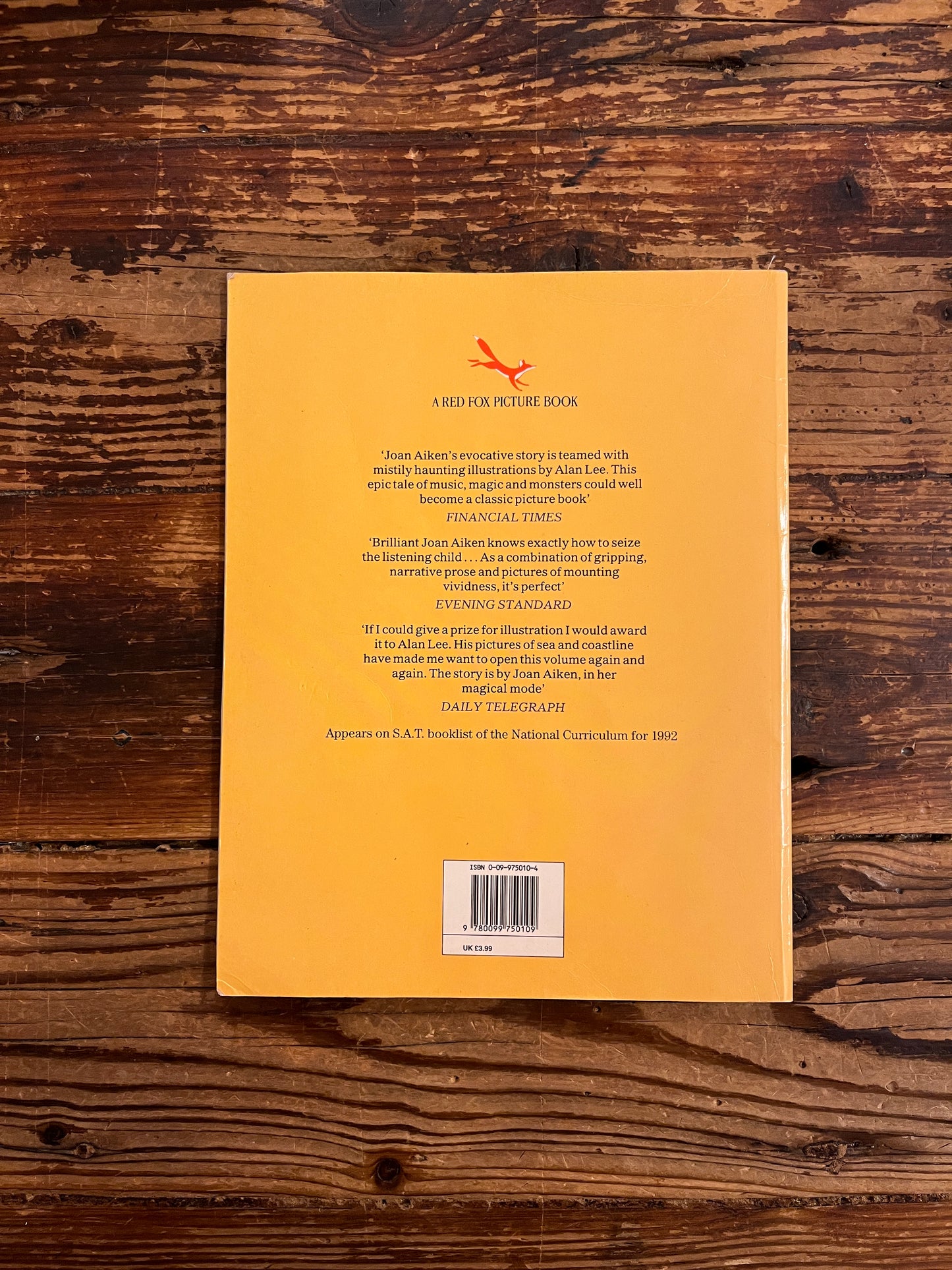 back coverr of book titled of 'The Moon's Revenge' on a wooden surface