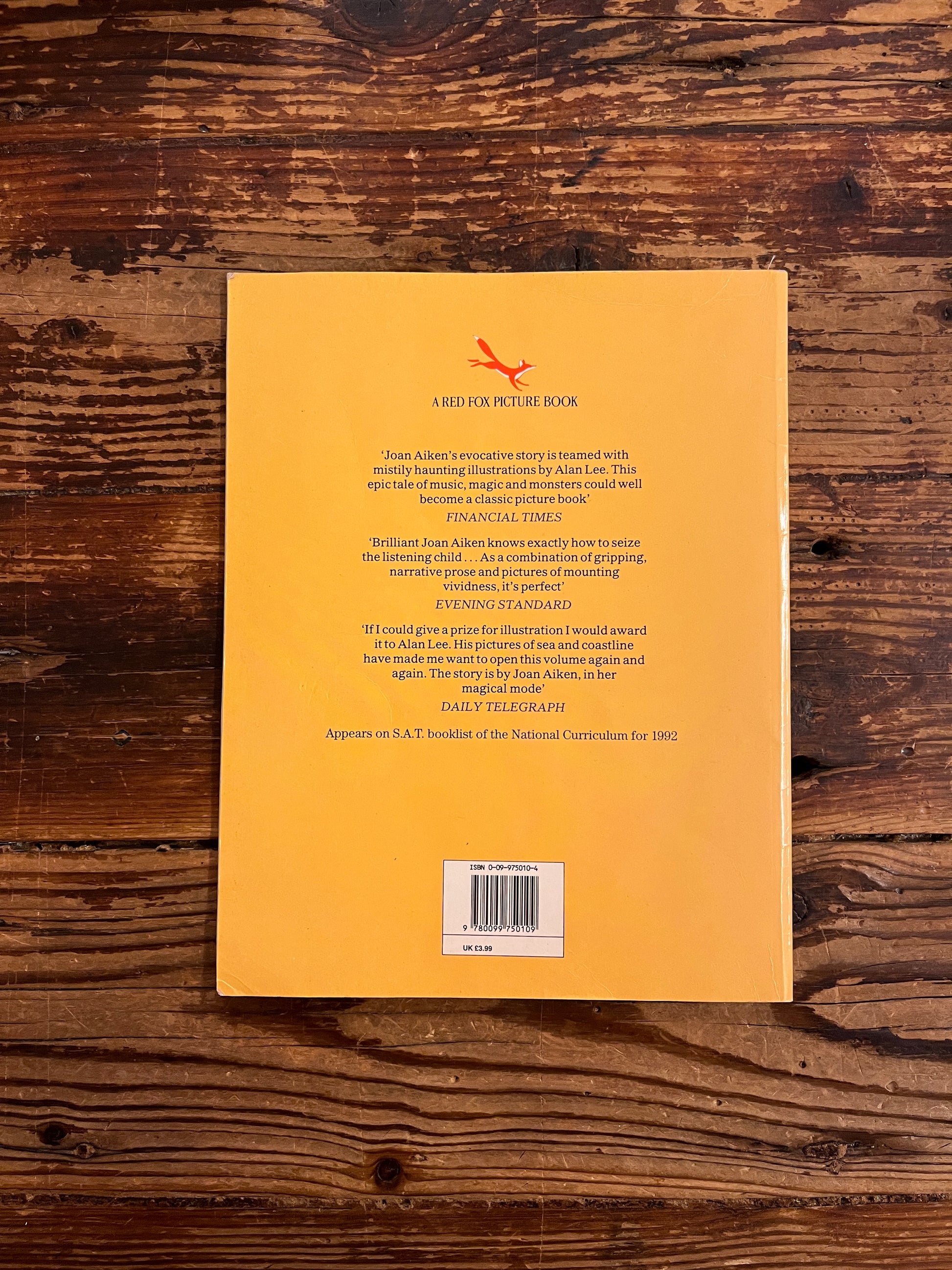 back coverr of book titled of 'The Moon's Revenge' on a wooden surface