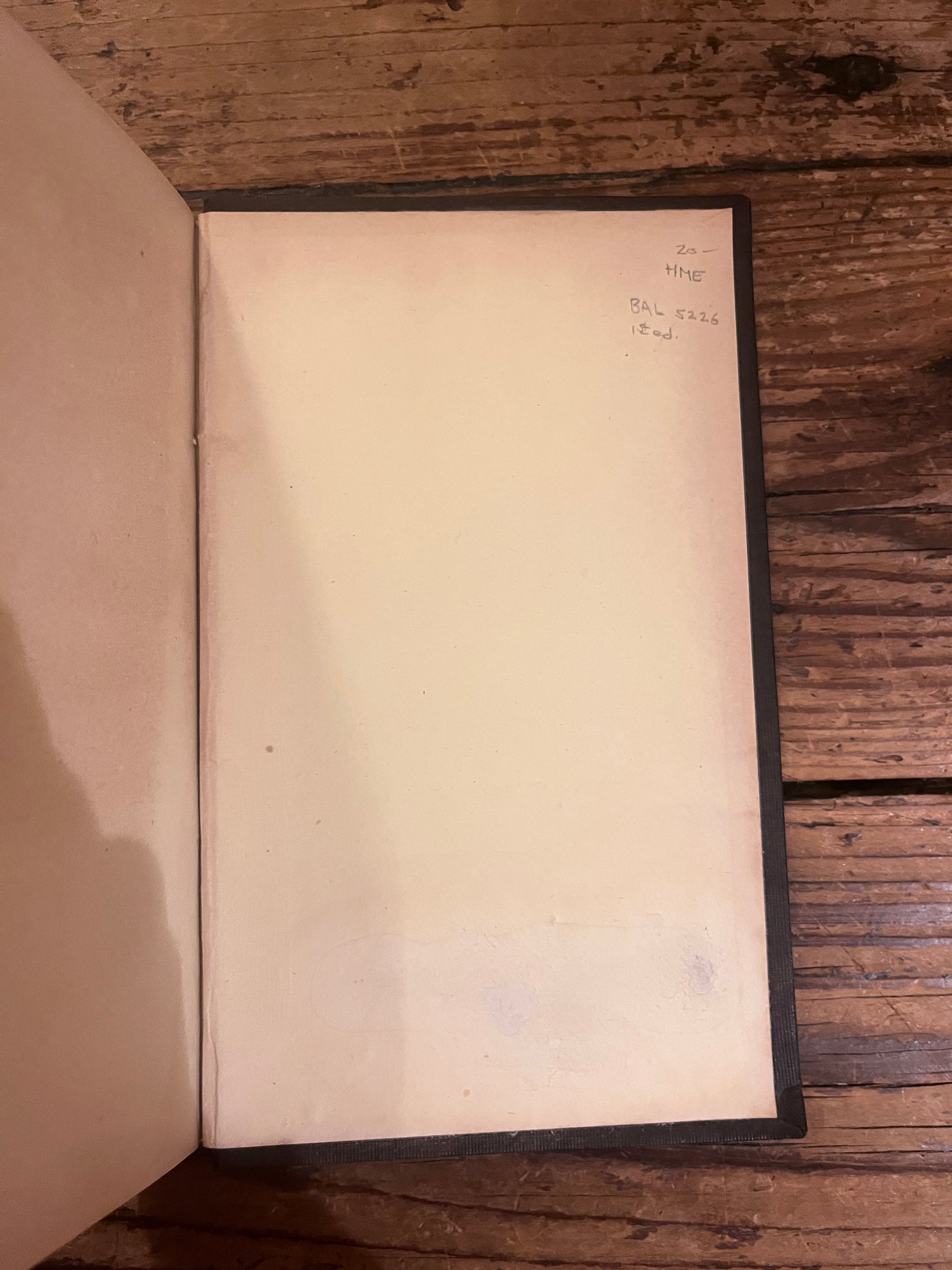 photo of the inside of the backcover of the book "english traits" on a wooden background