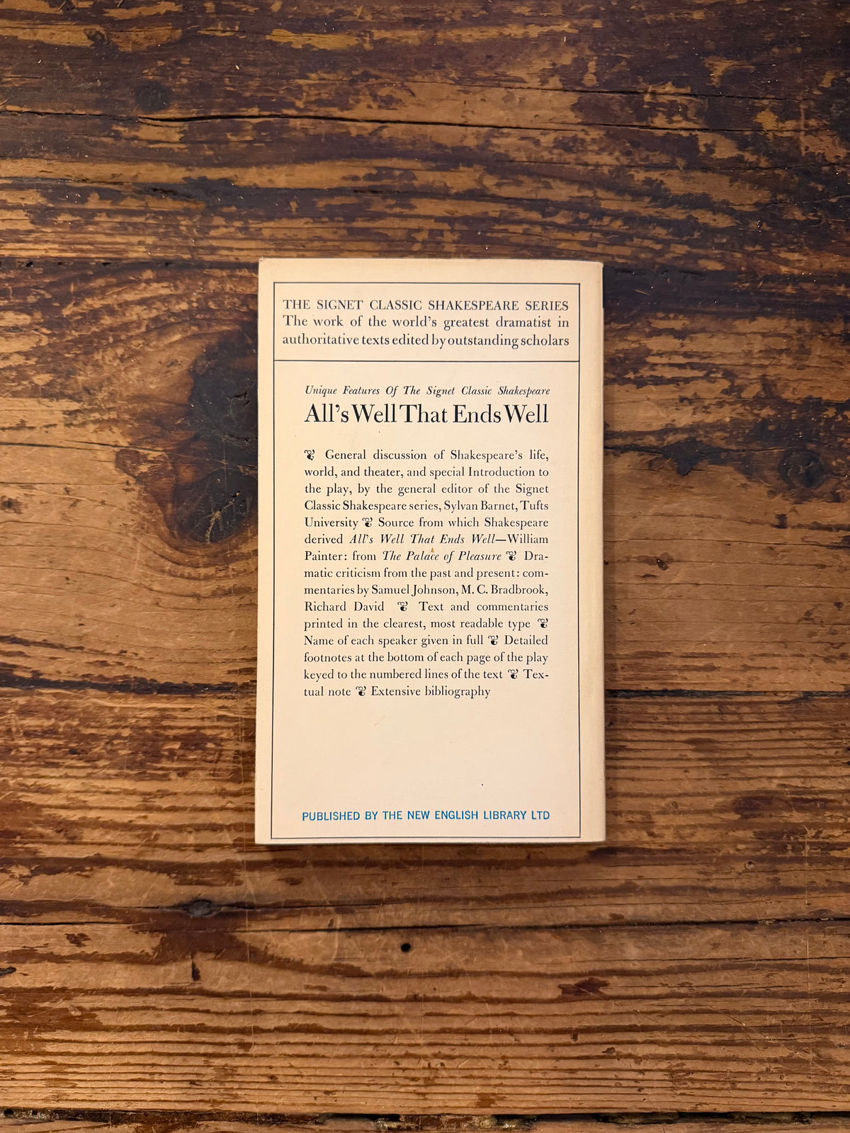 photo of the cover of the book "All's well that ends well" on a wooden background