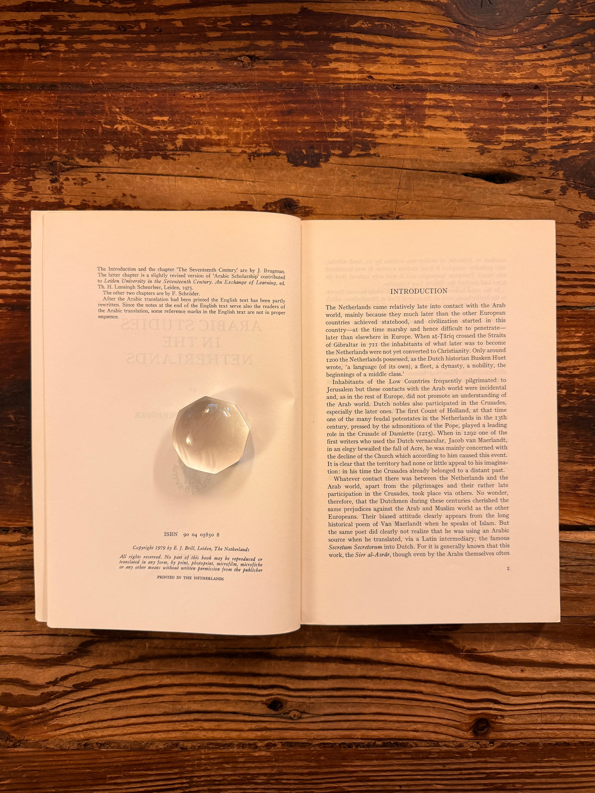 Open book titled 'Arabic Studies in the Netherlands' by J. Brugman en F. Schröder, lying on a wooden surface