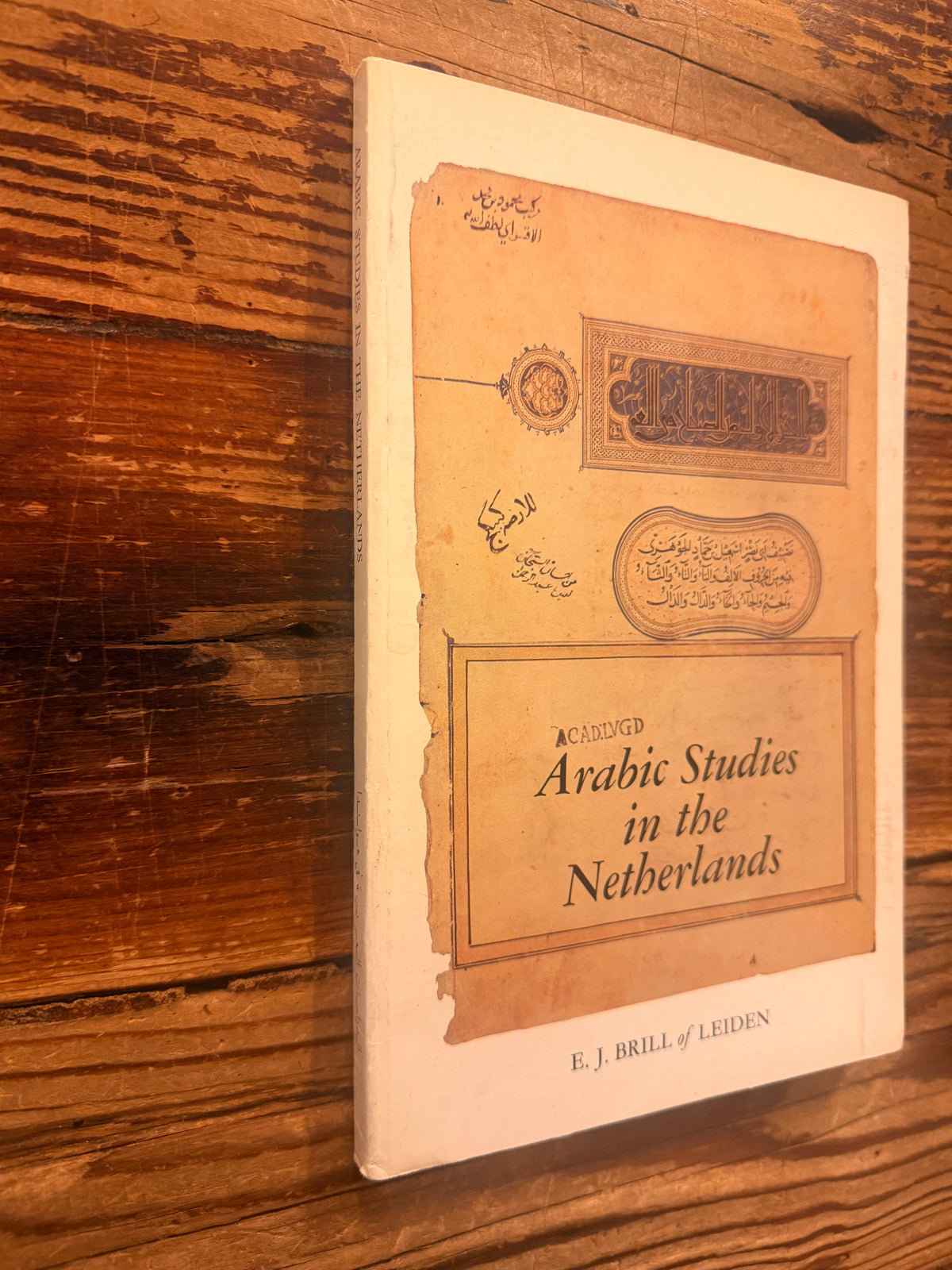 Front cover and spine of a book titled 'Arabic Studies in the Netherlands' by J. Brugman en F. Schröder, lying on a wooden surface