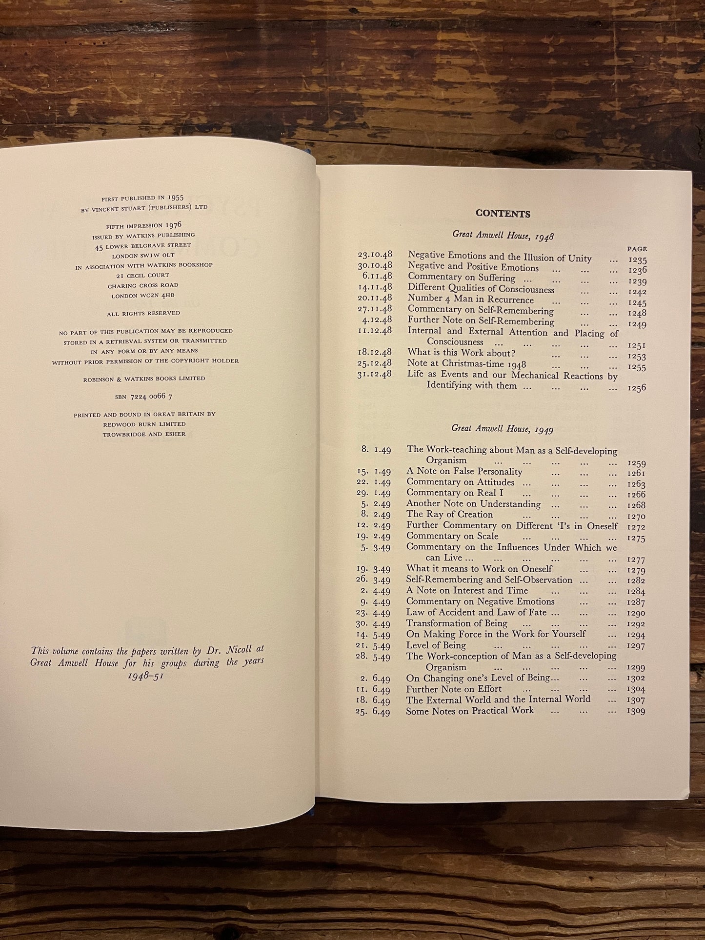 Open book titled 'Psychological Commentaries on the Teaching of Gurdjieff & Ouspensky volume 4' by Maurice Nicoll on a wooden surface