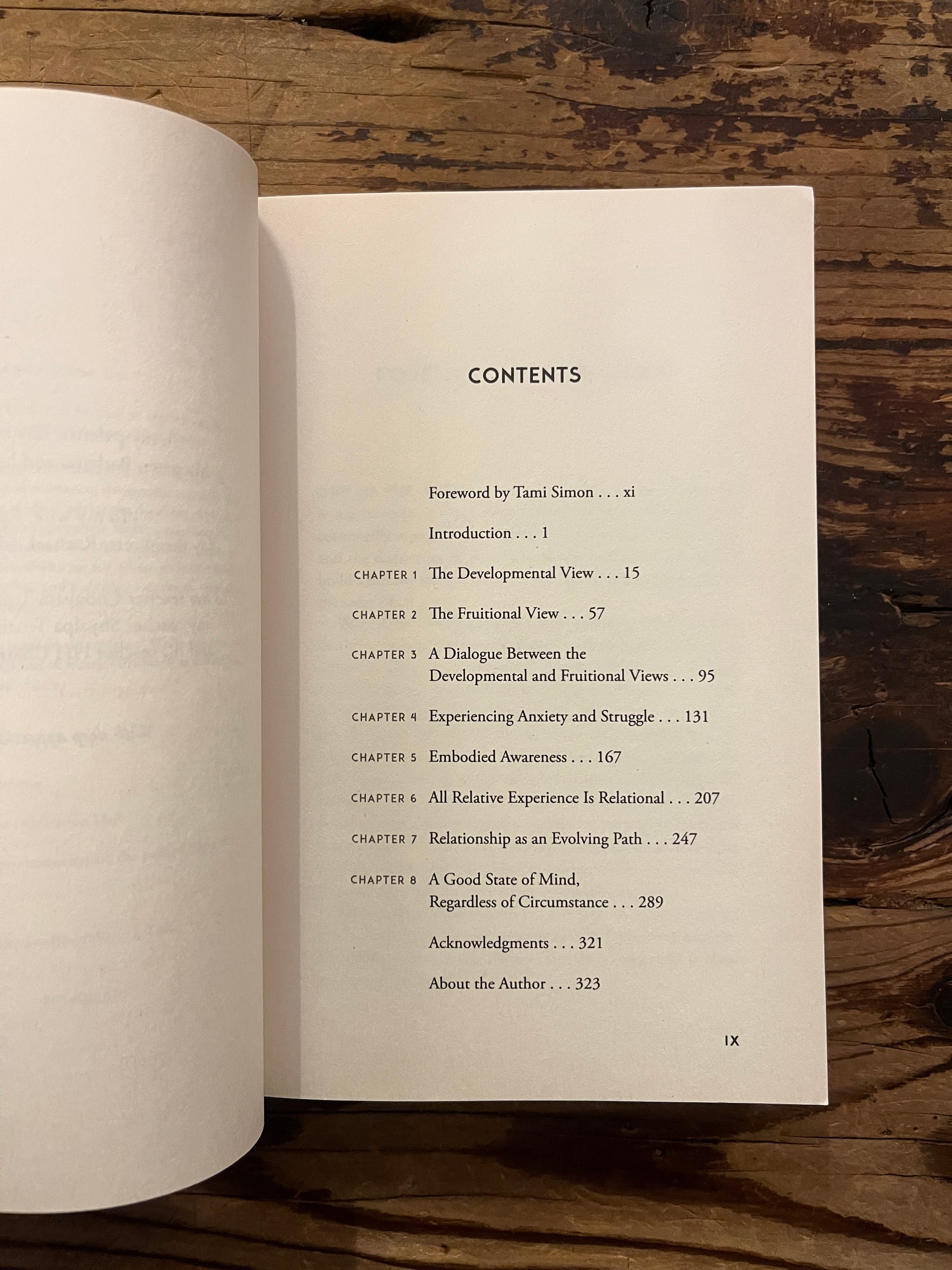 Open book titled 'Already Free' by Bruce Tift on a wooden surface