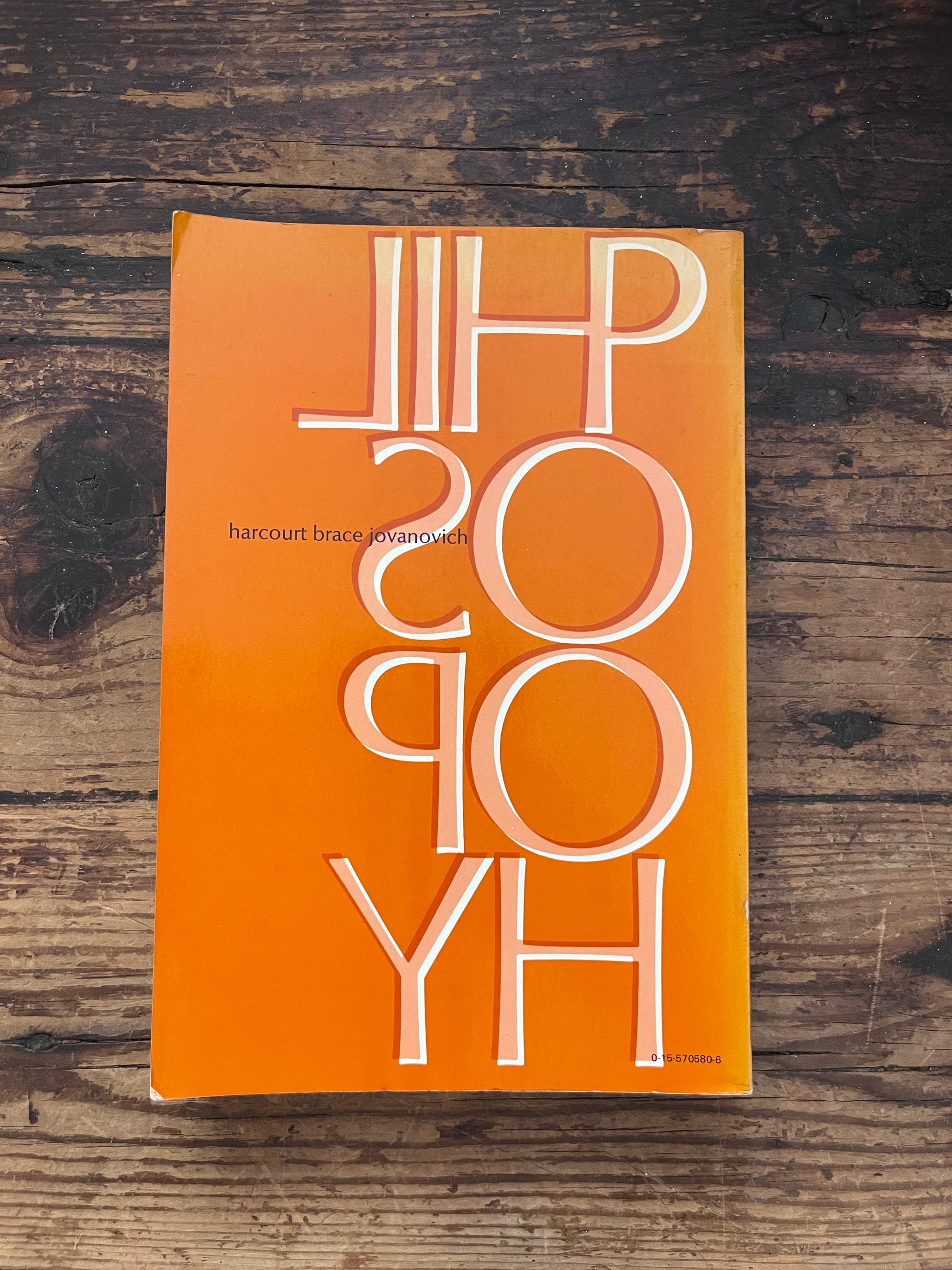 photo of the backcover of the book "philosophy of religion" on a wooden background