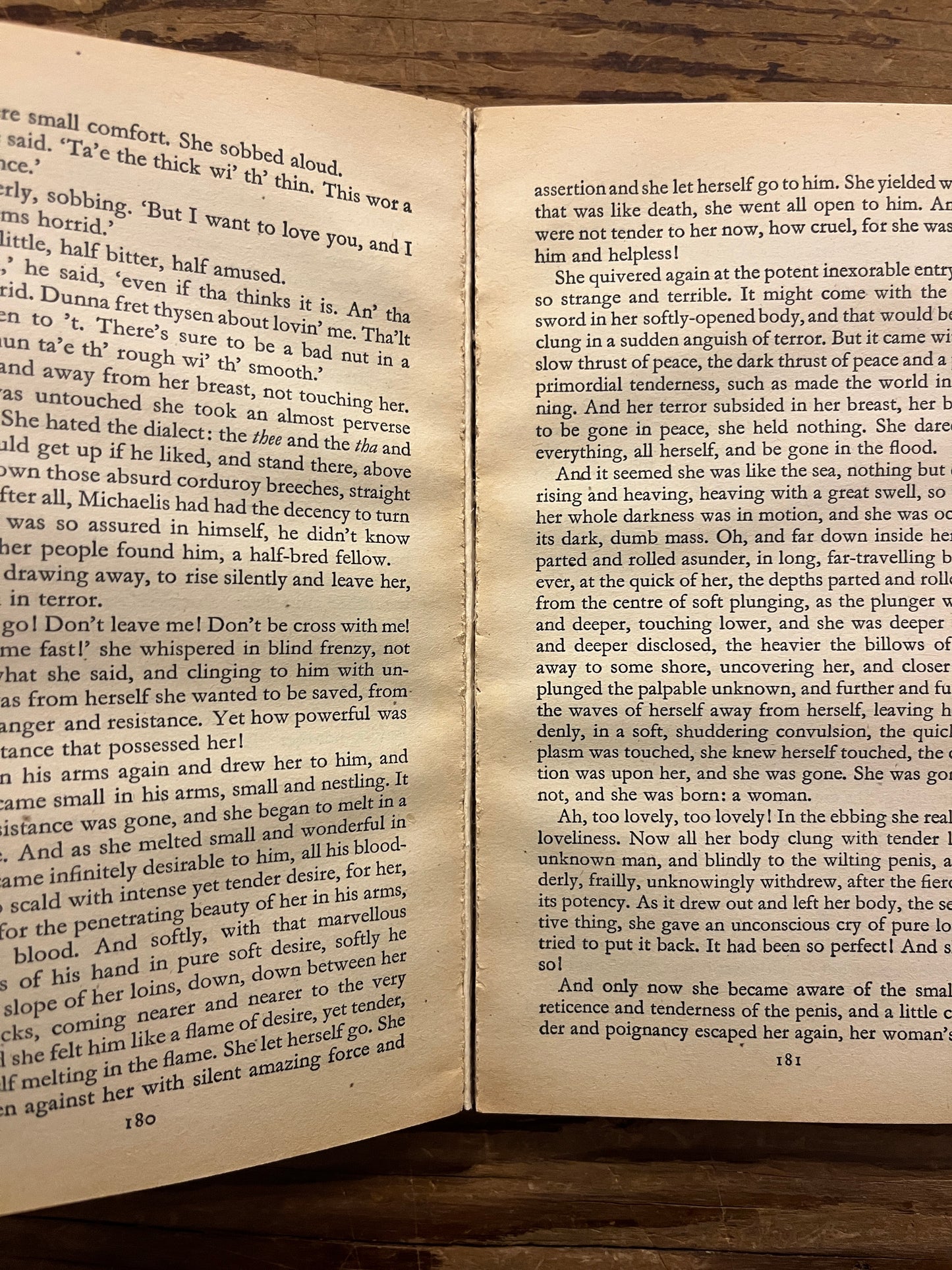 Open book titled 'Lady Chatterley's Lover' by D.H. Lawrence on a wooden surface