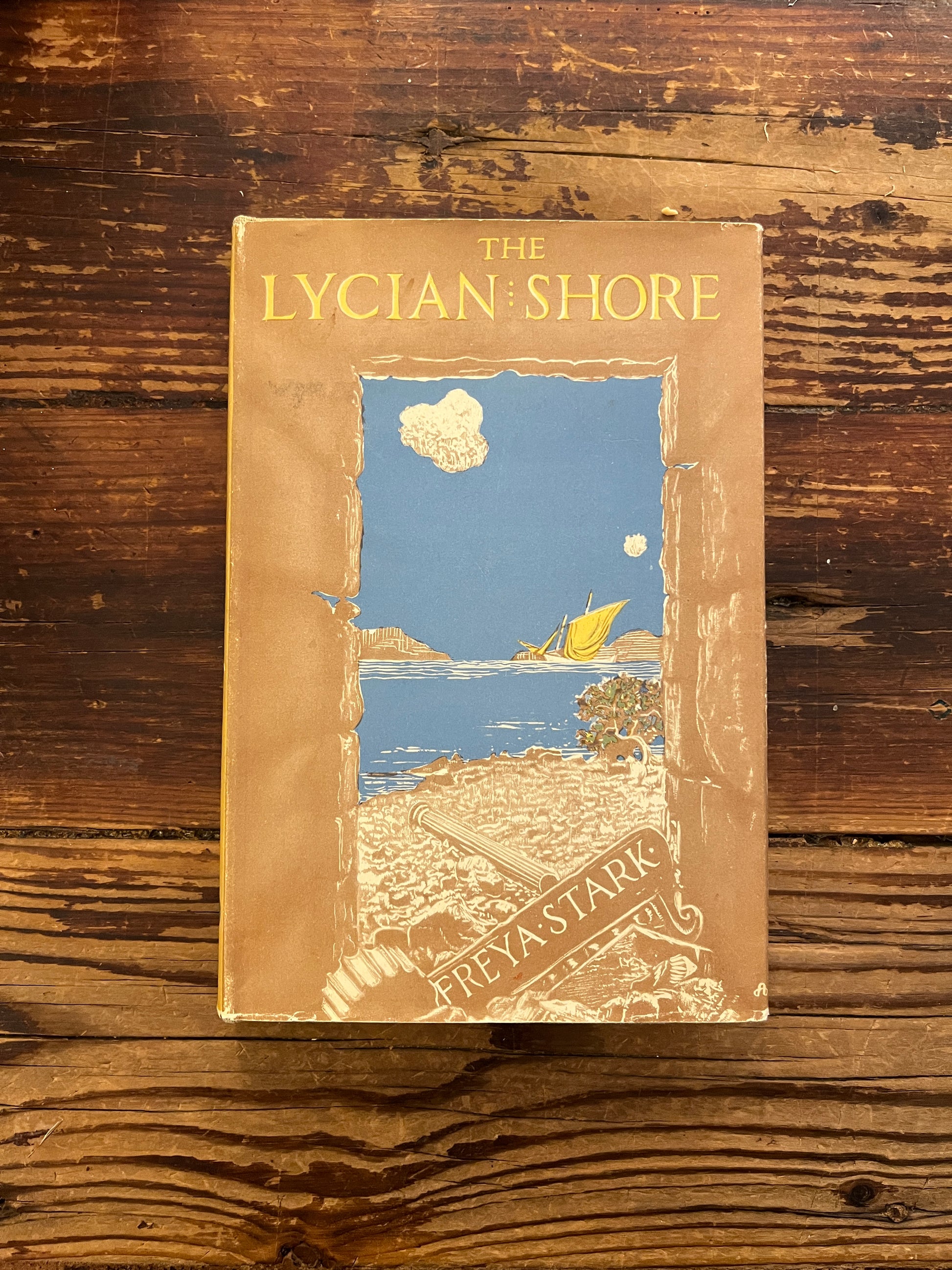 Front cover of book titled 'The Lycian Shore' by Freya Stark on a wooden surface