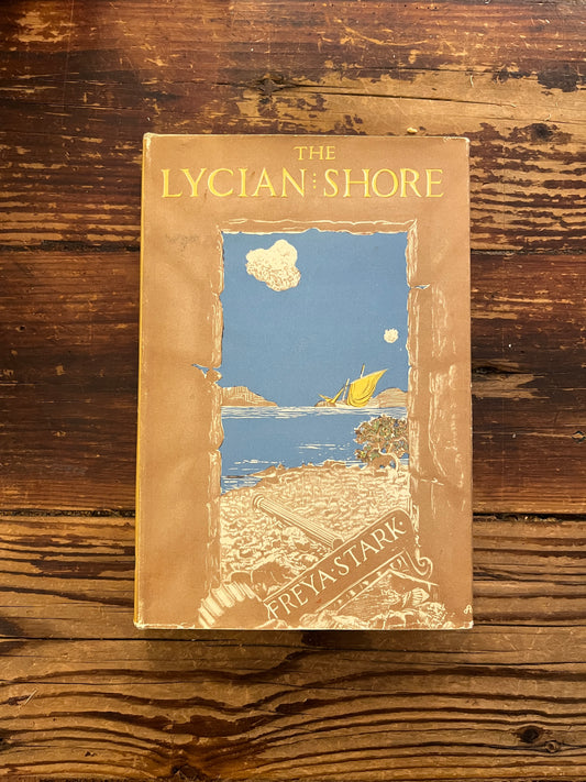 Front cover of book titled 'The Lycian Shore' by Freya Stark on a wooden surface