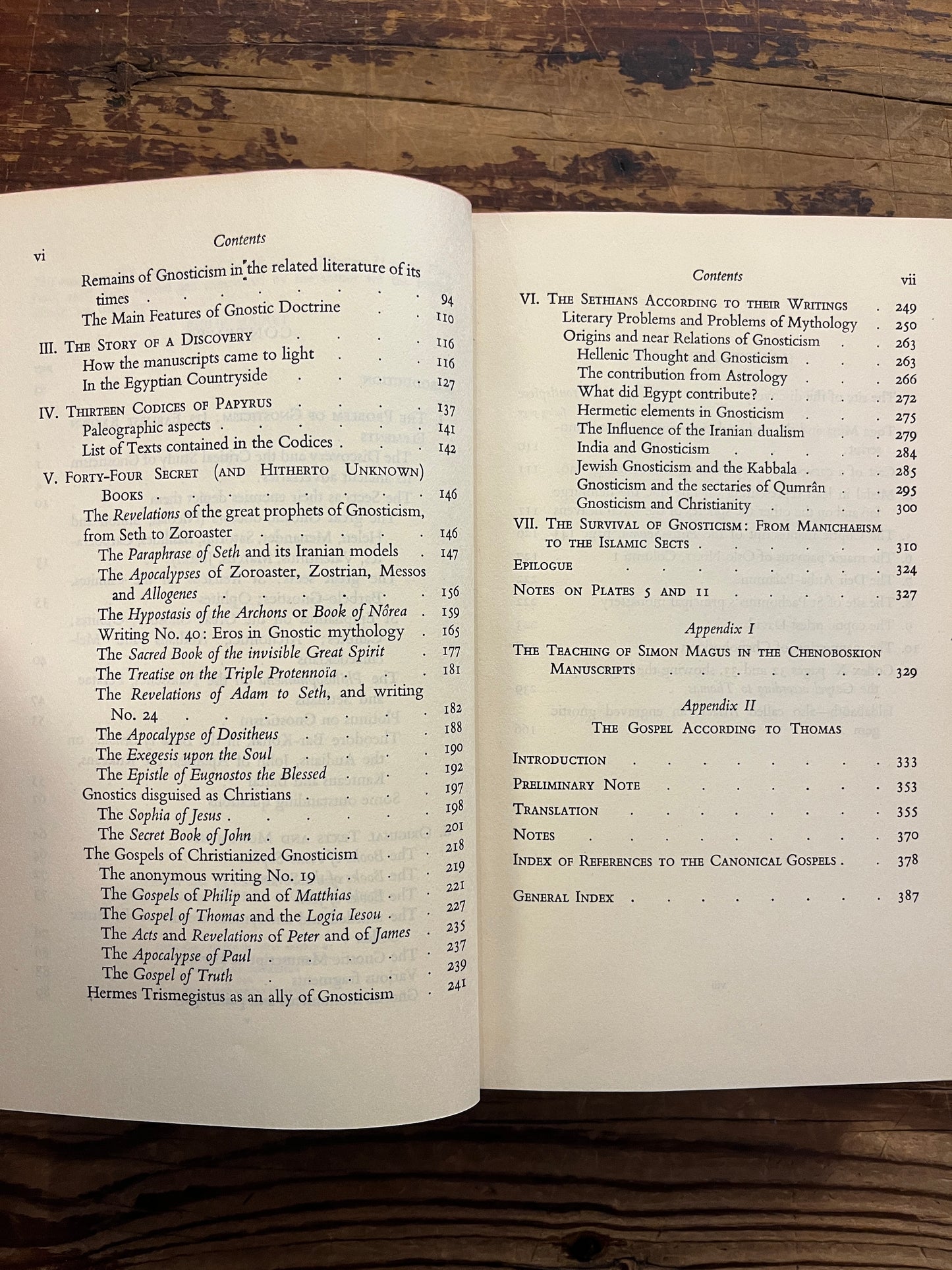 Open book titled 'The Secret Books of the Egyptian Gnostics' by Jean Doresse on a wooden surface