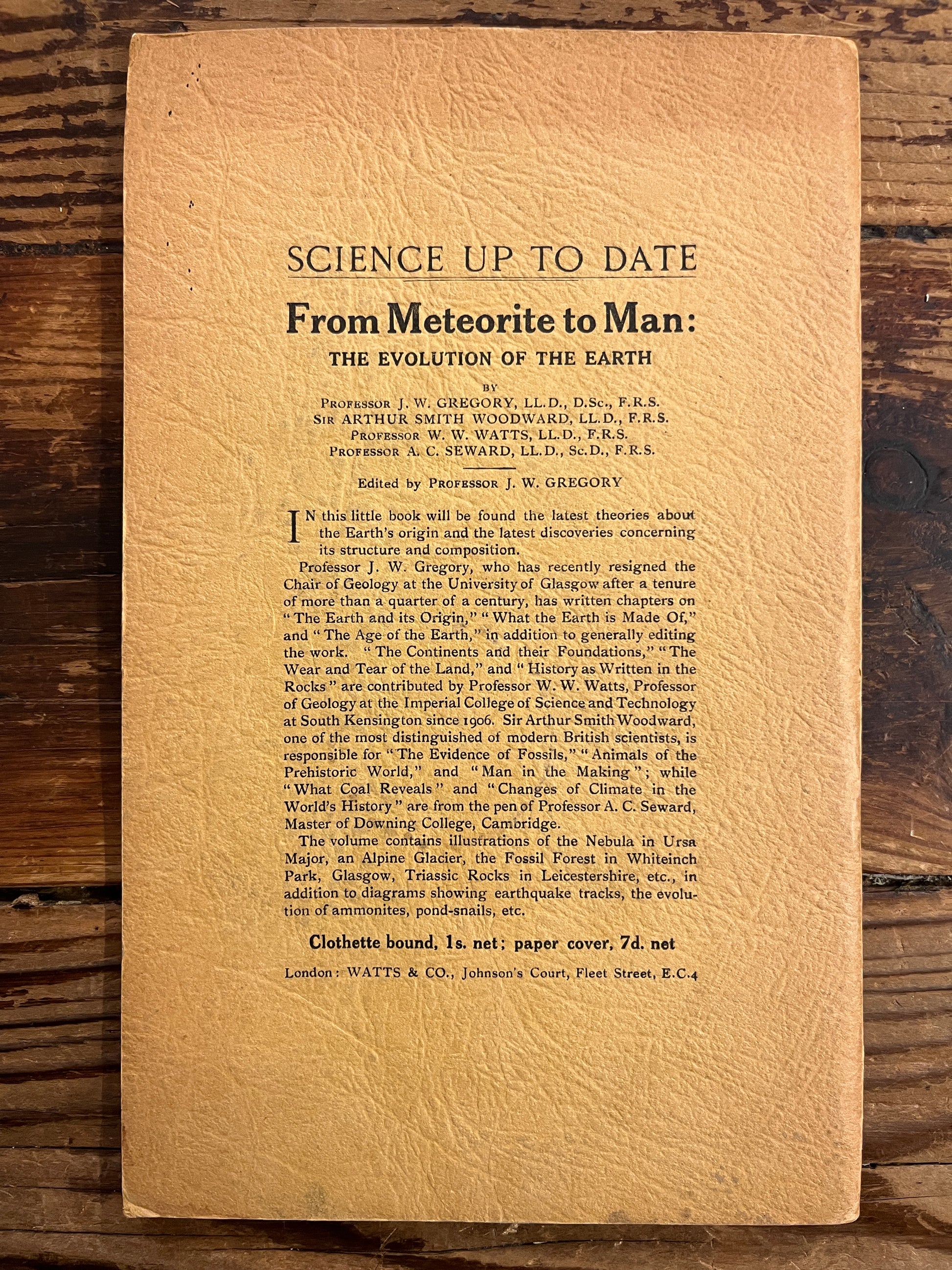 Vintage back cover of a booklet with text on a wooden surface