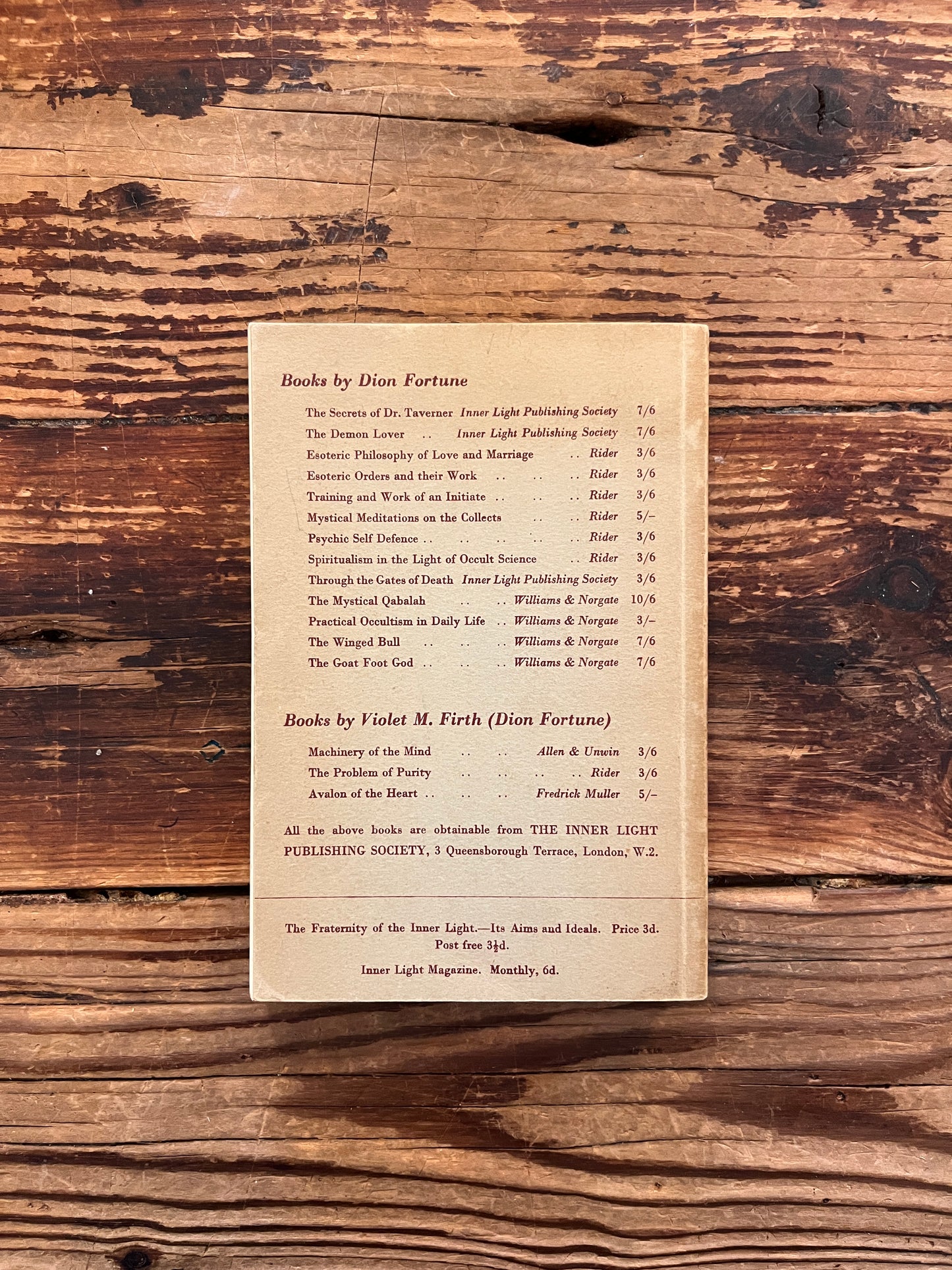 Back cover of rare first cheap edition of book titled 'sane occultism' by Dion Fortune on a wooden surface 