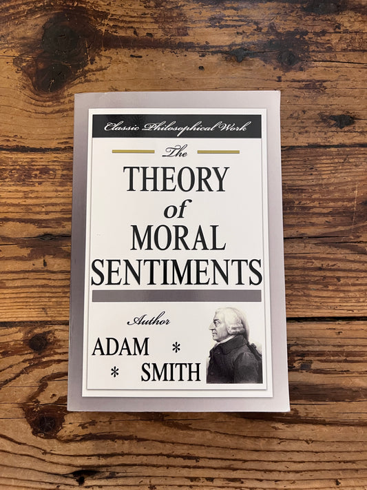 photo of the cover of the book "theory of moral sentiments" on a wooden background 
