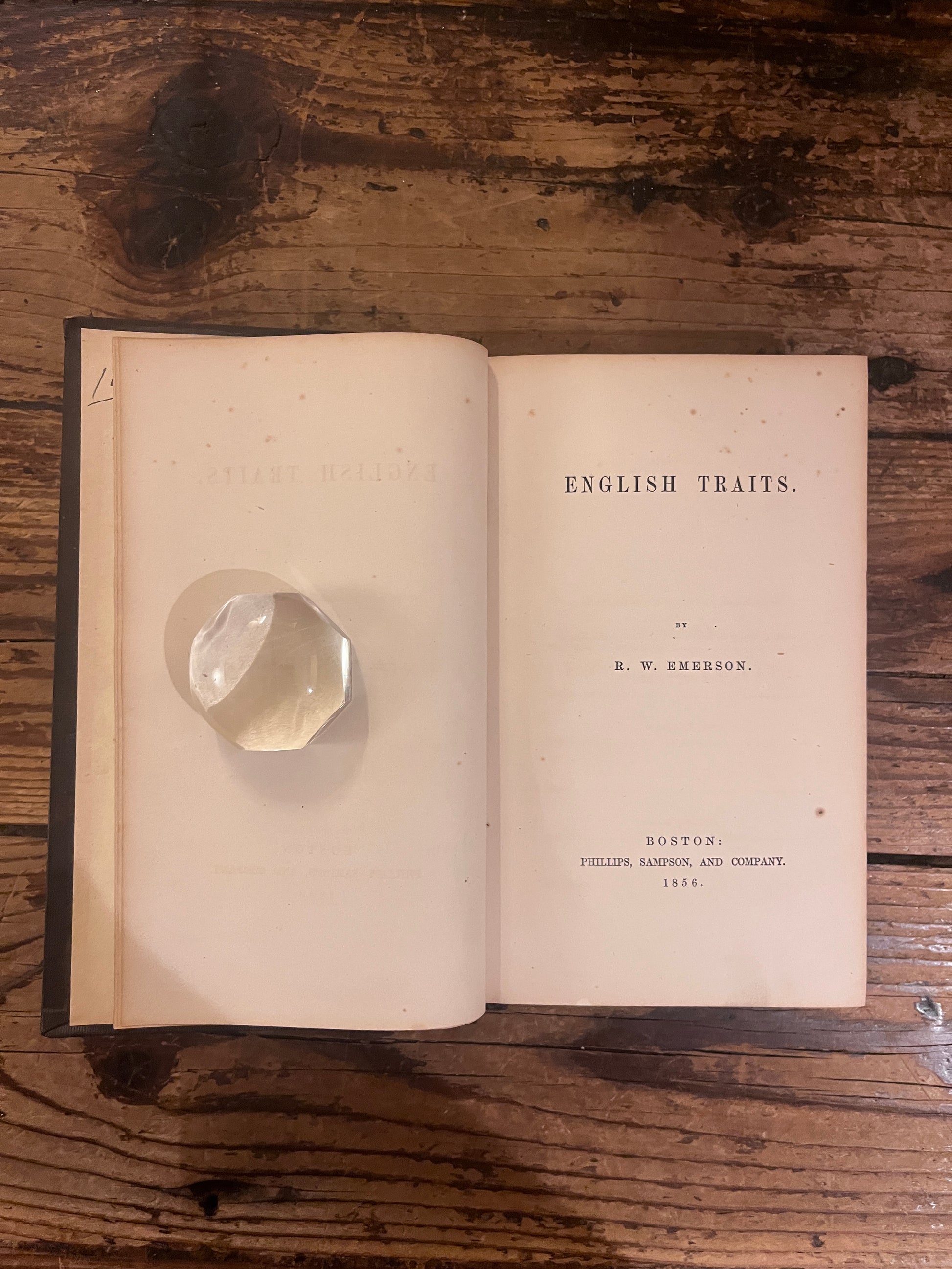 photot of the title page of the book "english traits" on a wooden background