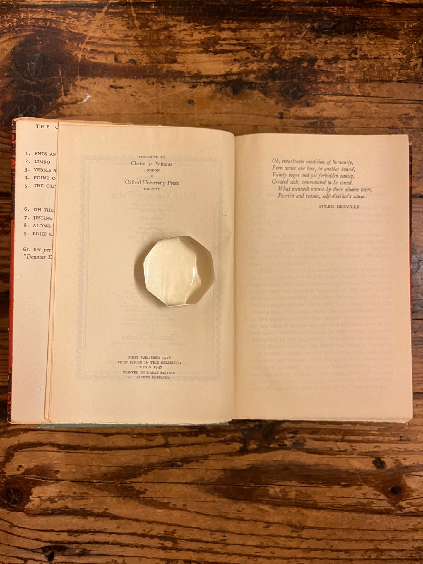 photo of the edition page of the book "Point Couter Point" on a wooden background