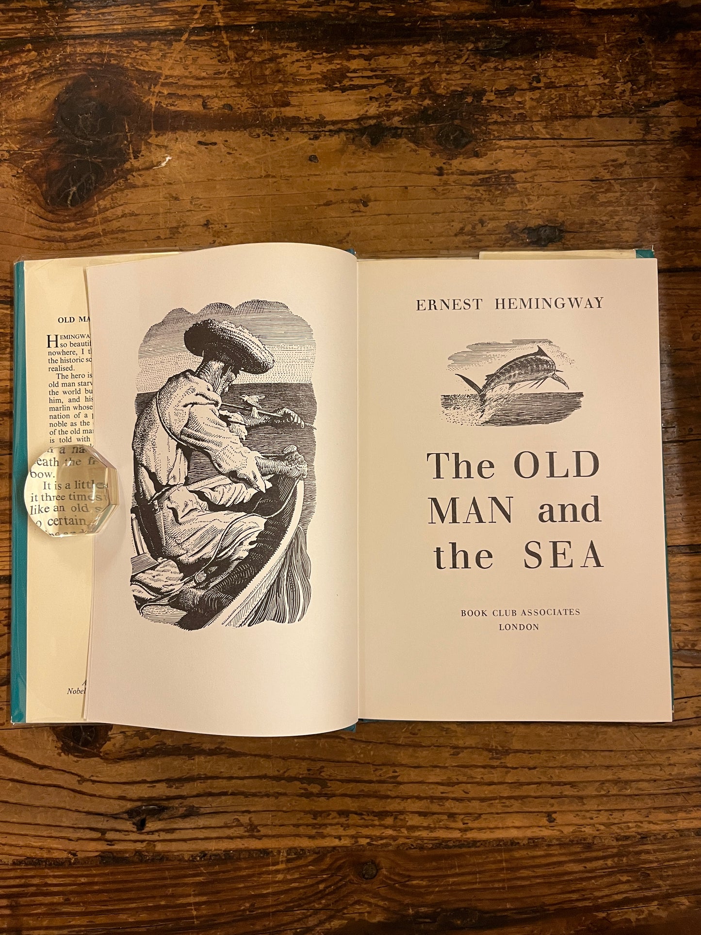 photo of the title page of the book "the old man and the sea"on a wooden backgroung