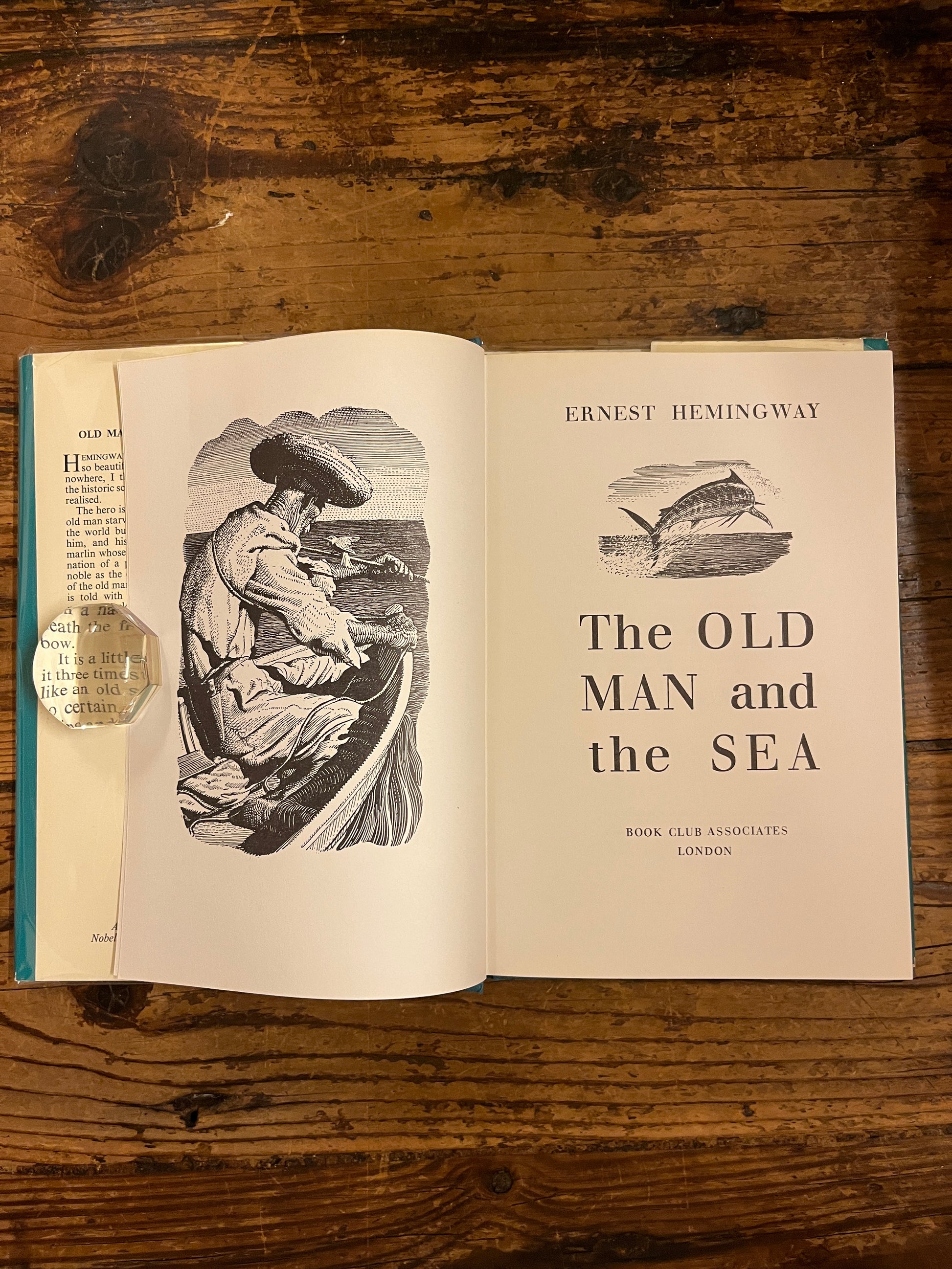 photo of the title page of the book "the old man and the sea"on a wooden backgroung