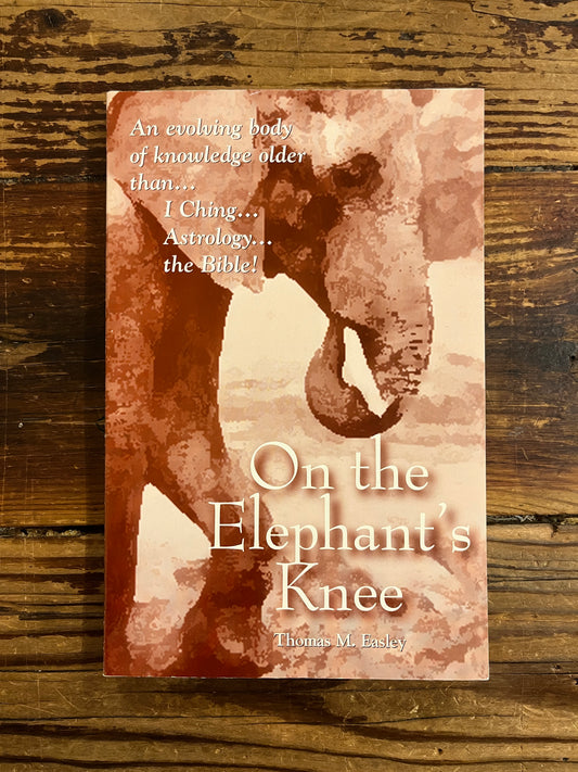 Front cover of a book titled 'On the Elephant's Knee' on a wooden surface