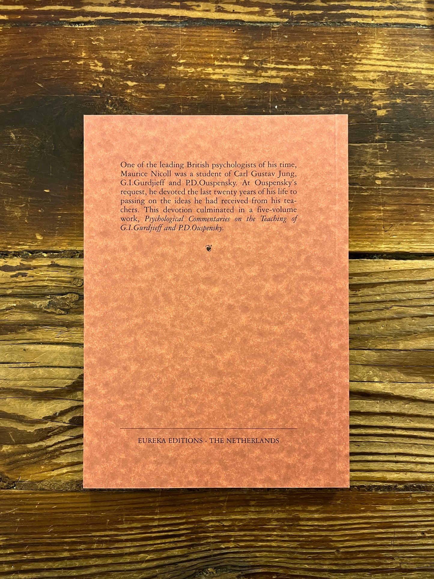 Back cover book titled 'Informal Work Talks and Teachings 1940-1950' by Maurice Nicoll on a wooden surface