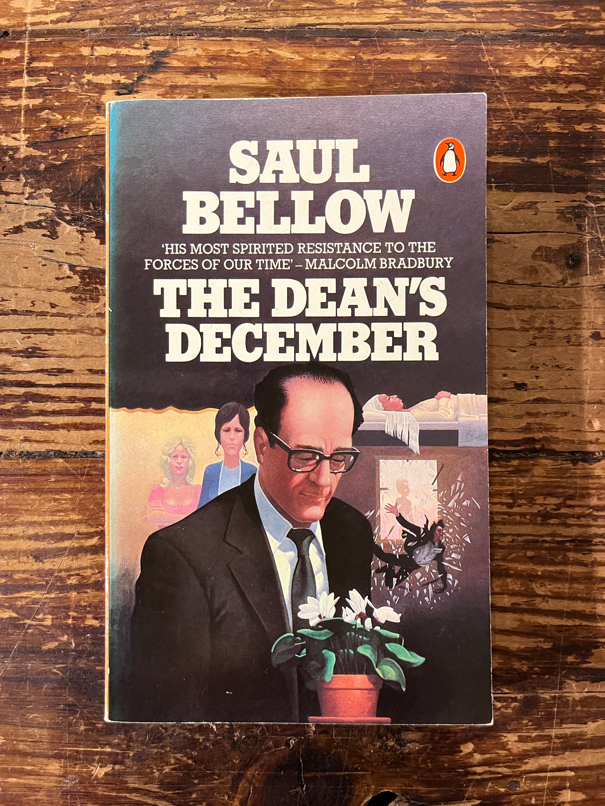 photo of the cover of the book " the dean's december" on a wooden background