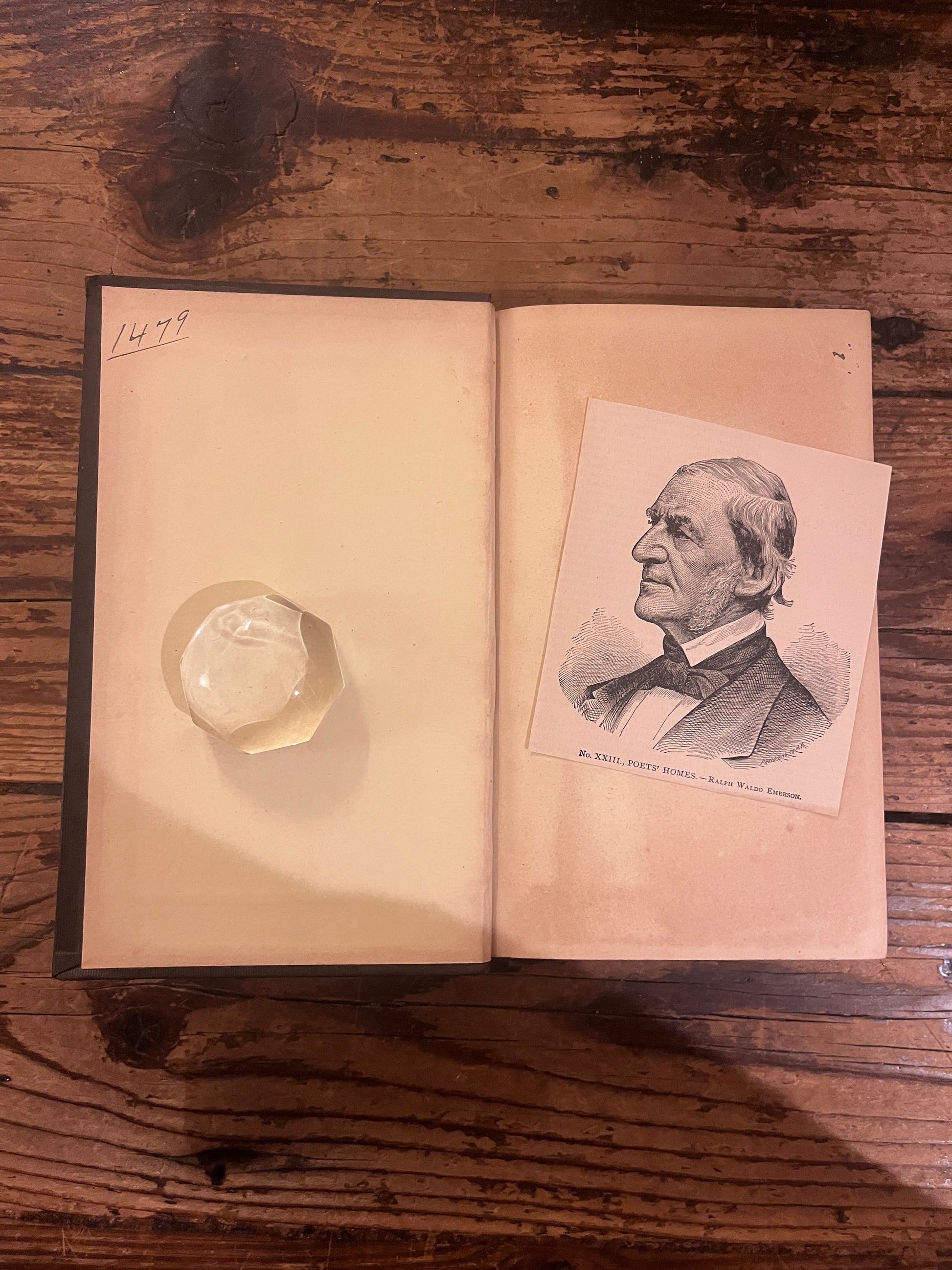 photo of the inside of the front cover and first page of the book "english traits" on a wooden background