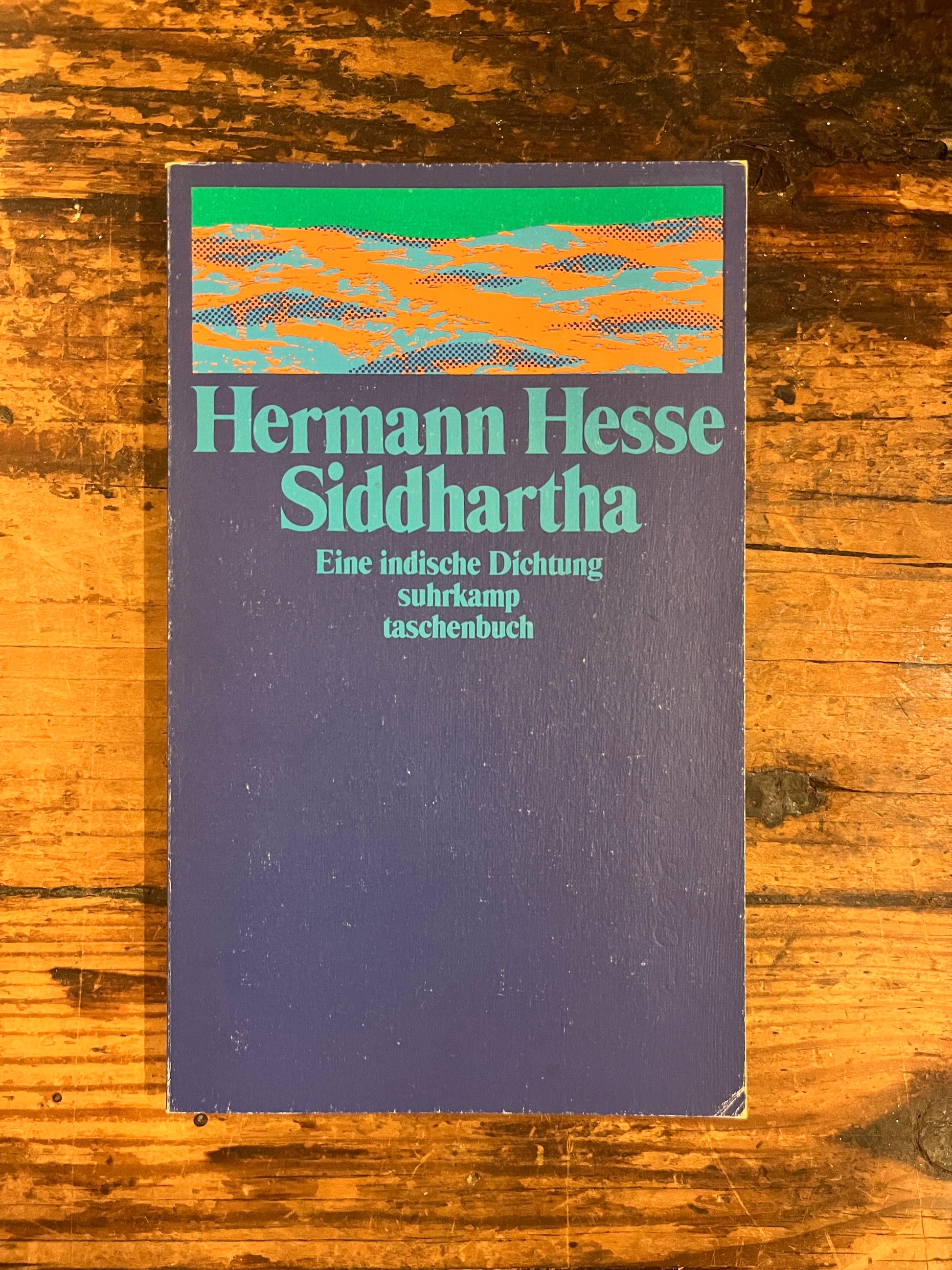 photo from the over of the book "Siddharta"on a wooden background