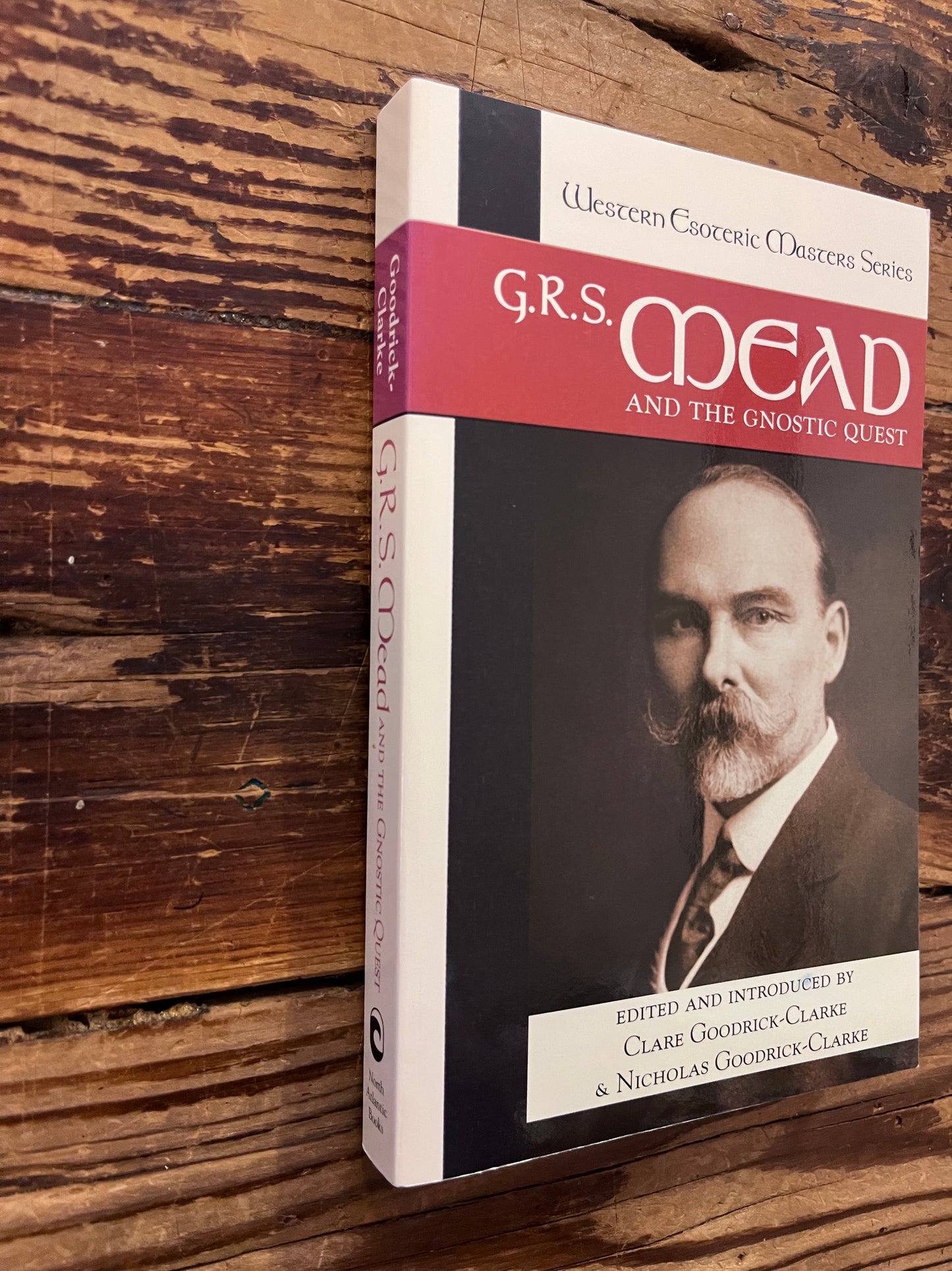 Spine and front cover of book with the title 'G.R.S. Mead and the Gnostic quest' by Clare Goodrick-Clarke on a wooden surface 