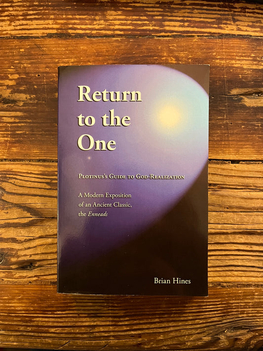 Front cover of book titled 'Return to the One, Plotinus guide to God-Realization' by Brian Hines on a wooden surface