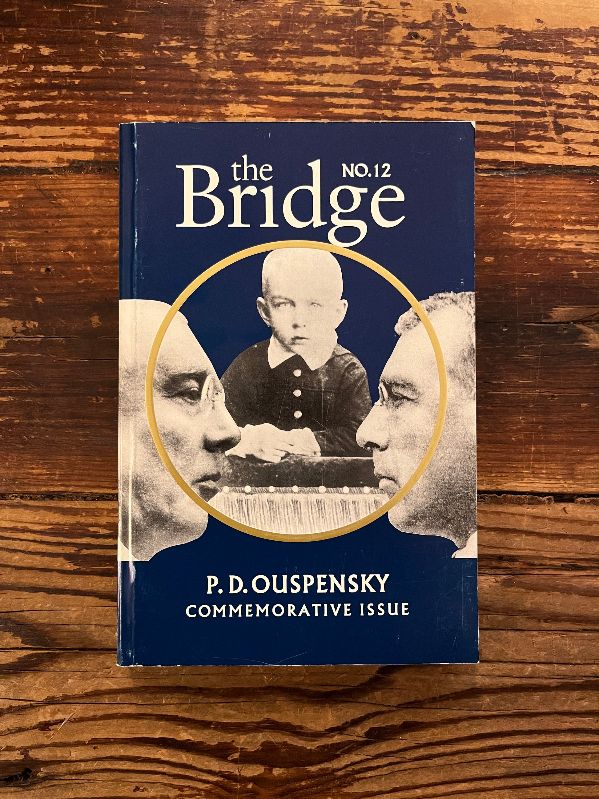 Front cover of book titled 'The Bridge n.12 P.D. Ouspensky  commemorative issue' on a wooden surface