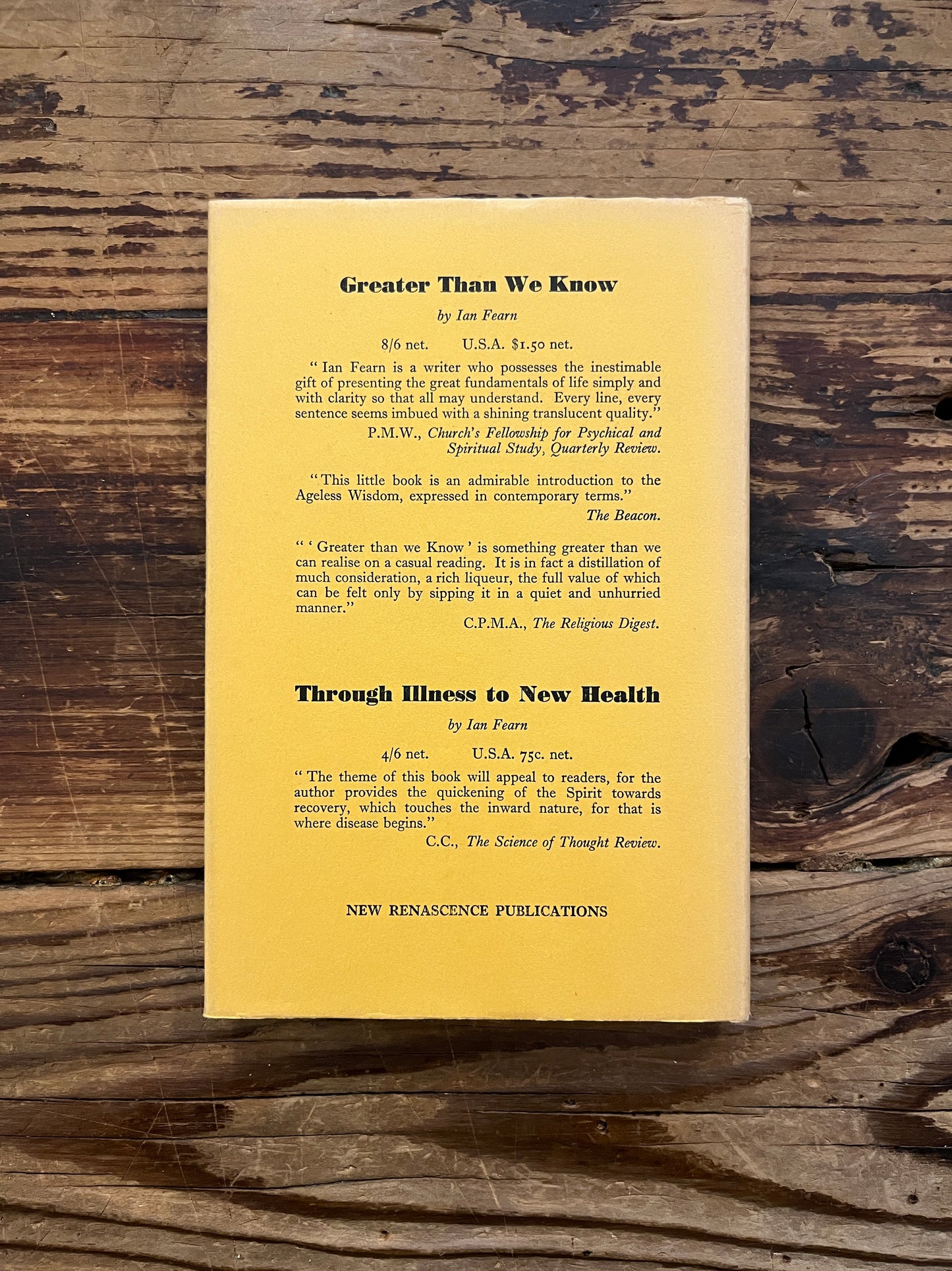 Back cover of book with the title 'Think Again' by Ian Fearn on a wooden surface