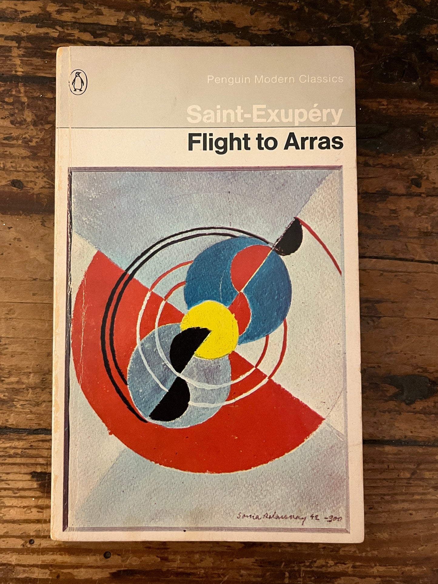 front cover of the  book "Flight to arras" on a wooden background