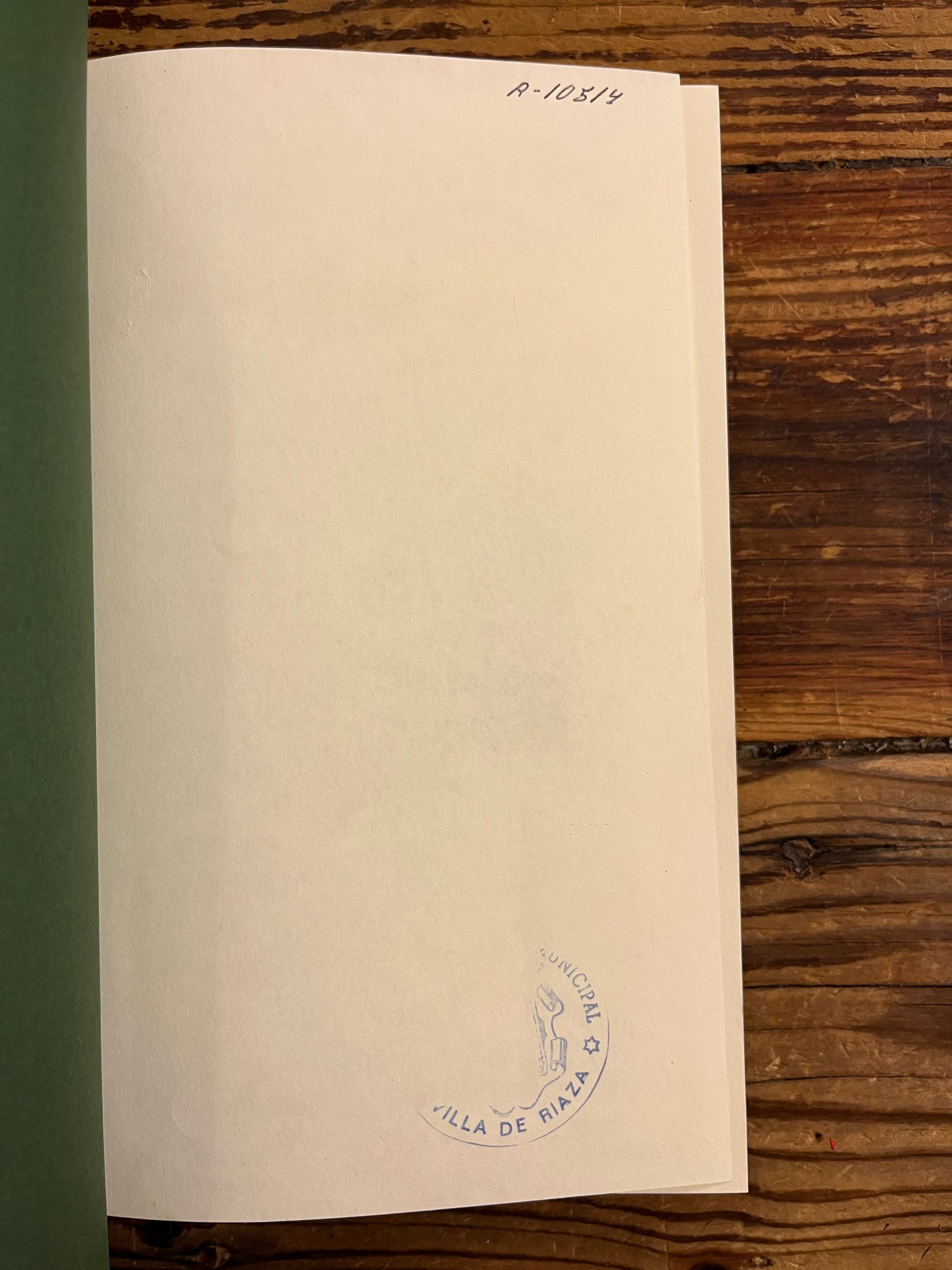  'The Hobbit' by J.R.R. Tolkien on a wooden surface, photo showing a library stamp