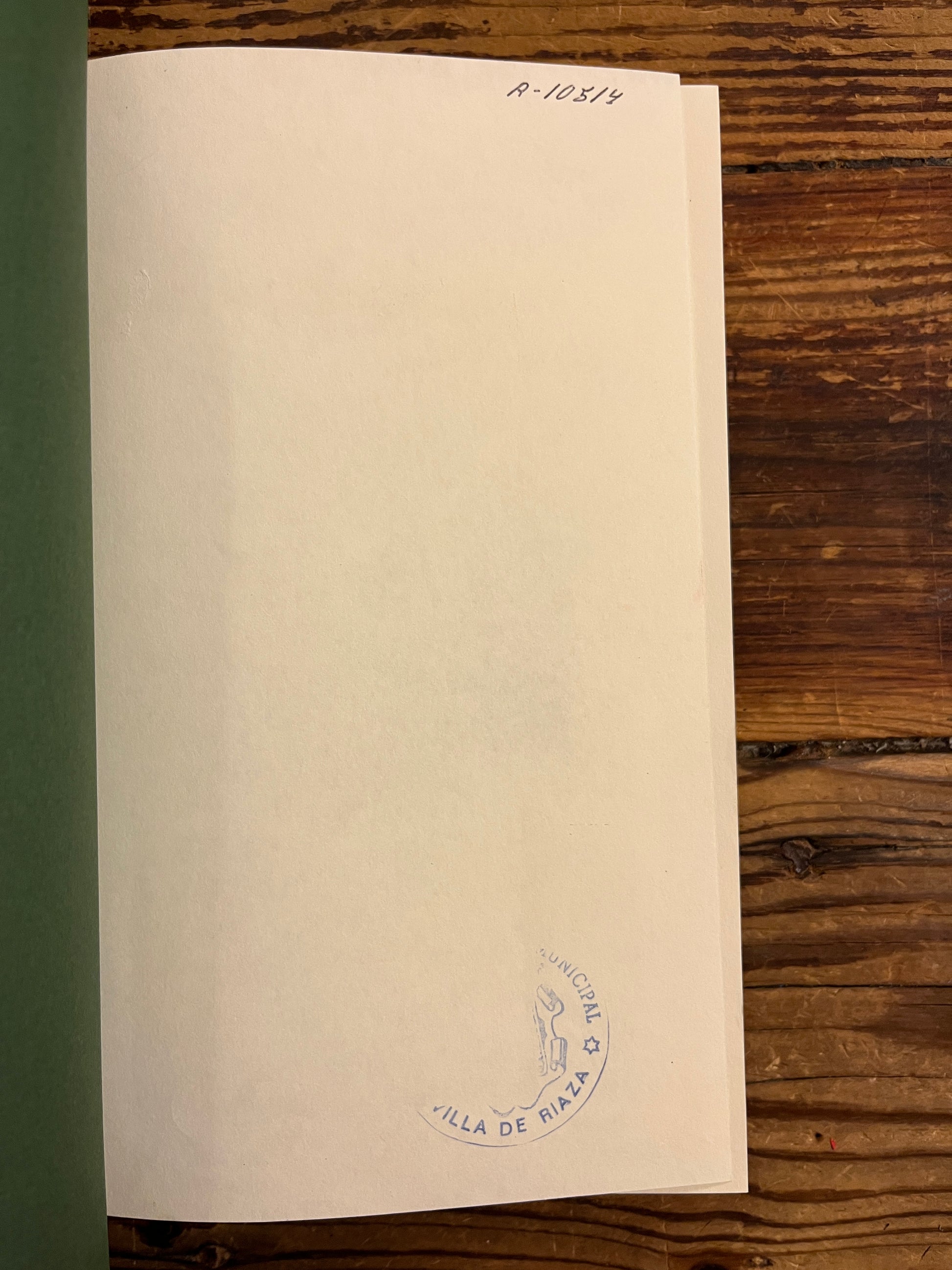  'The Hobbit' by J.R.R. Tolkien on a wooden surface, photo showing a library stamp