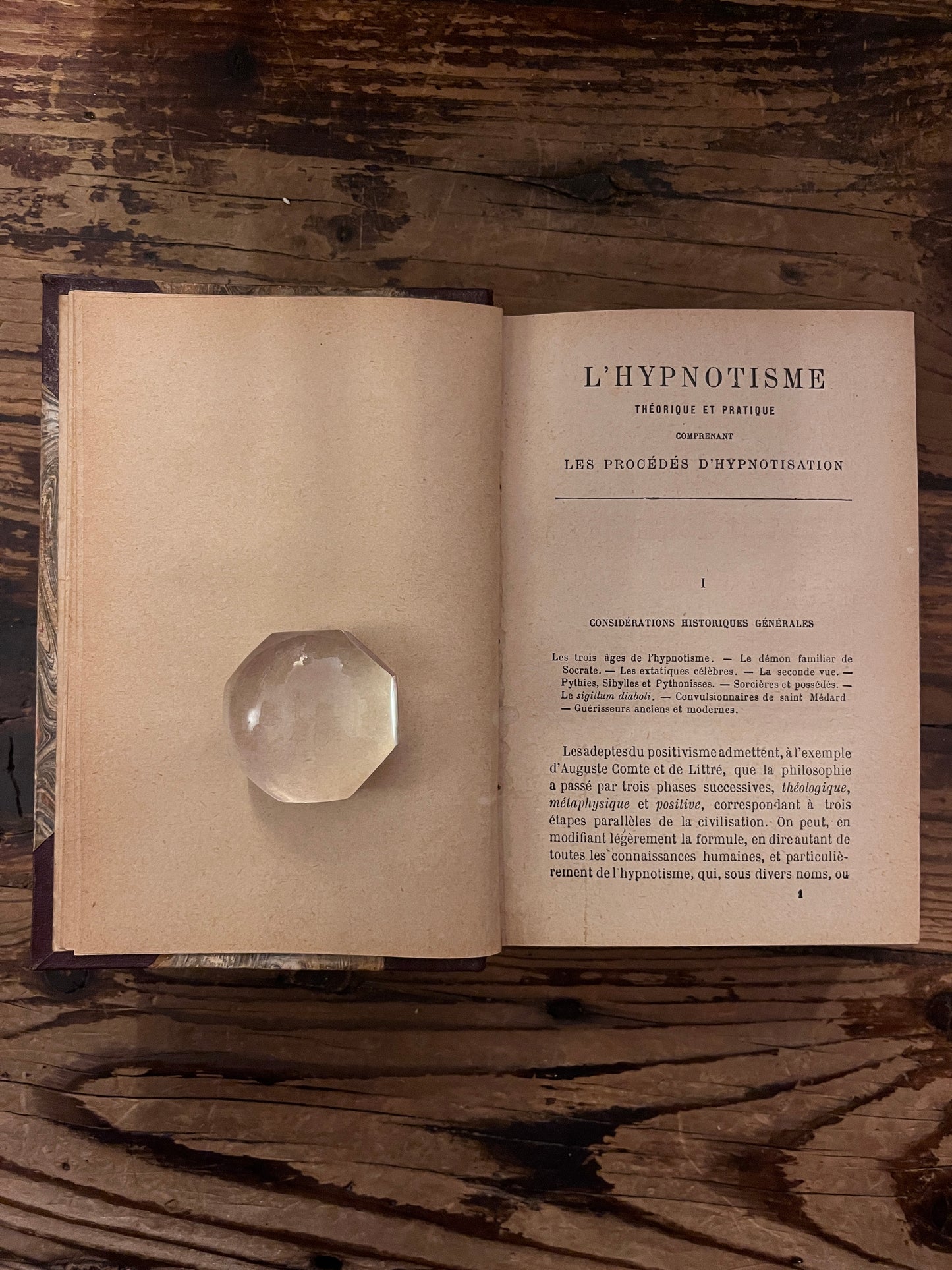 photo de la premiere page du livre "l 'hypnotisme" sur fond de bois