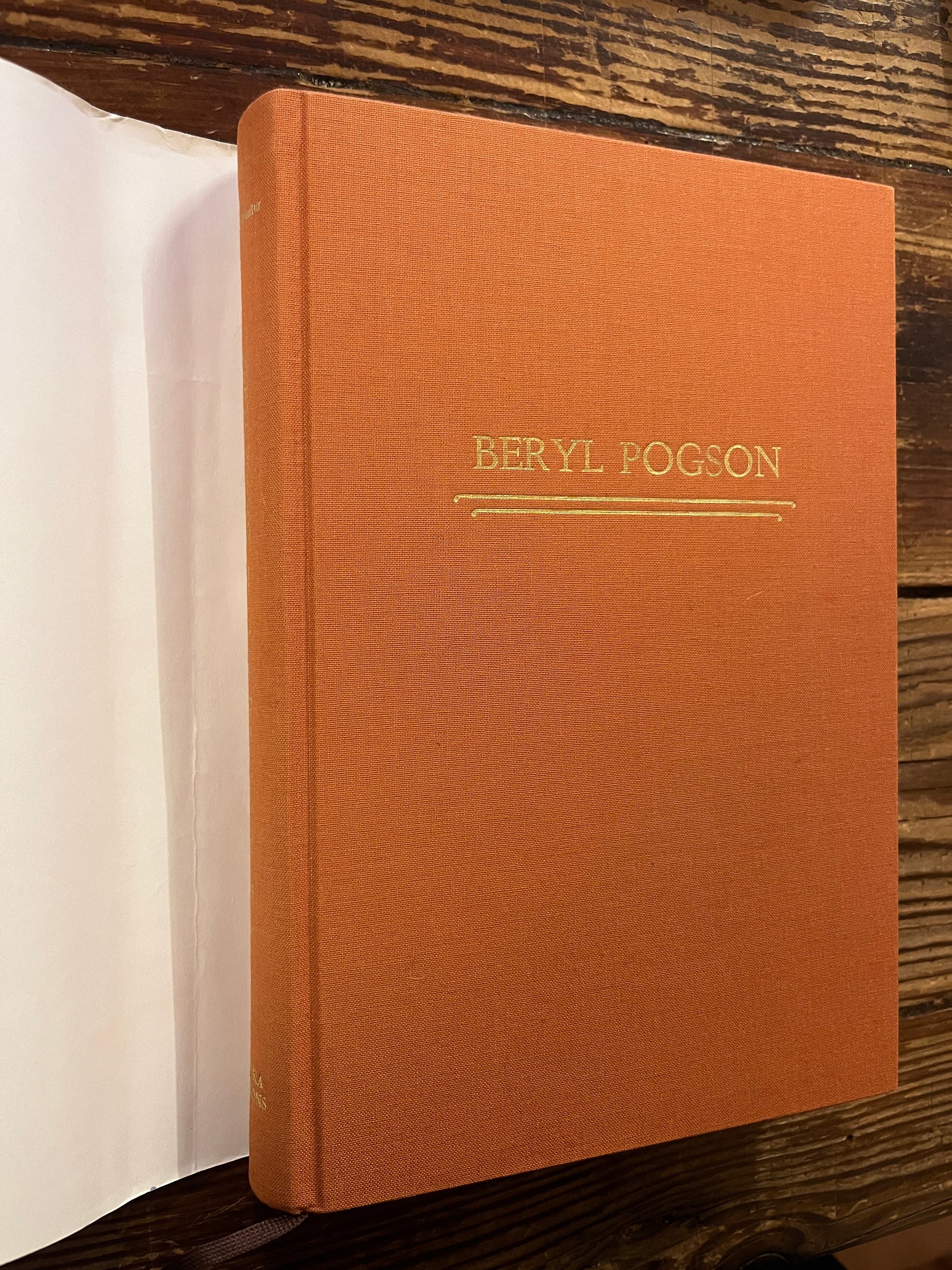 book titled 'Beryl Pogson: A Life Dedicated to the Work' by Bob Hunter on a wooden surface