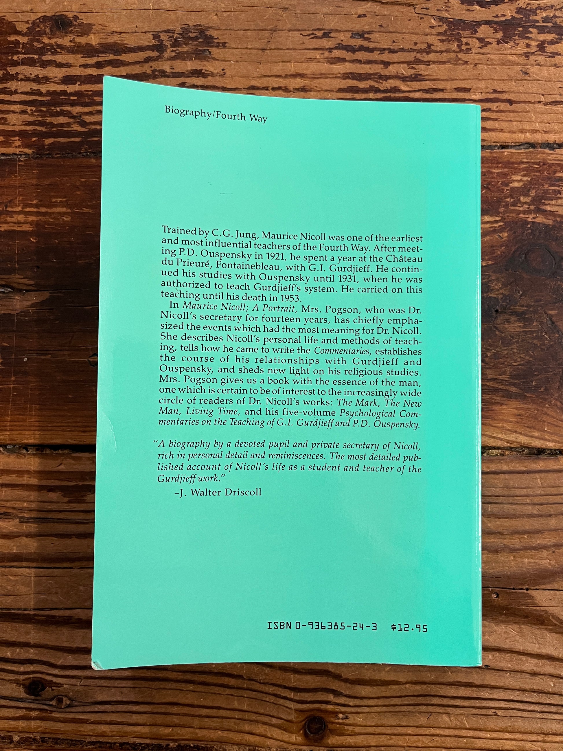 Back cover of book titled 'Maurice Nicoll: A Portrait' by Beryl Pogson on a wooden surface.