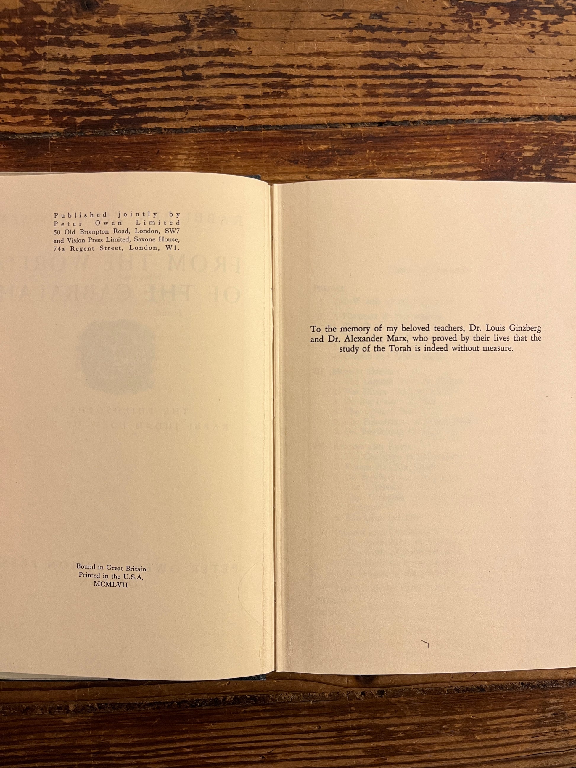 open book titled 'From the World of the Cabbalah' on a wooden surface